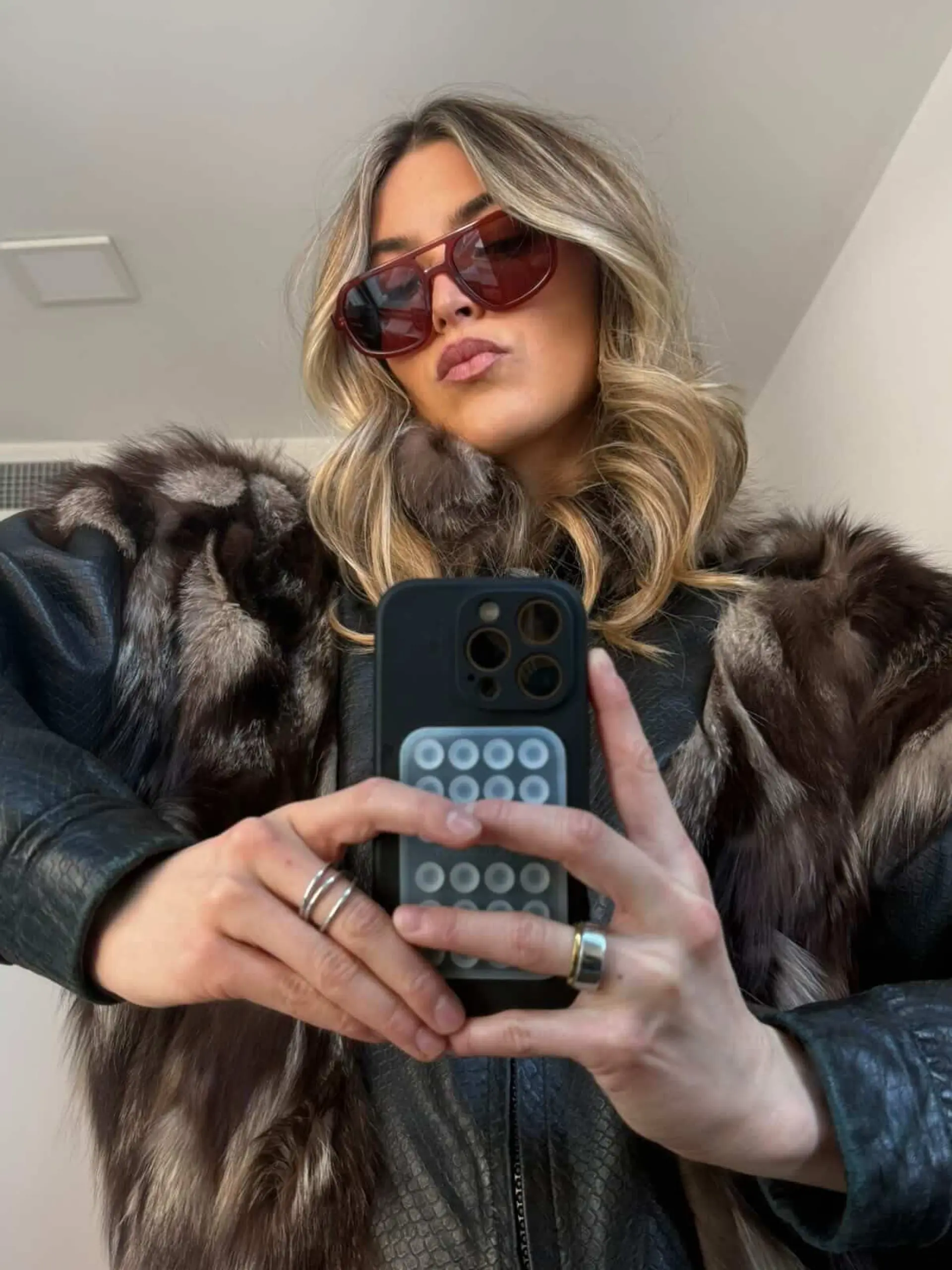 Medium-length dimensional blonde hair styled in voluminous, soft loose waves with brighter face-framing pieces. 1