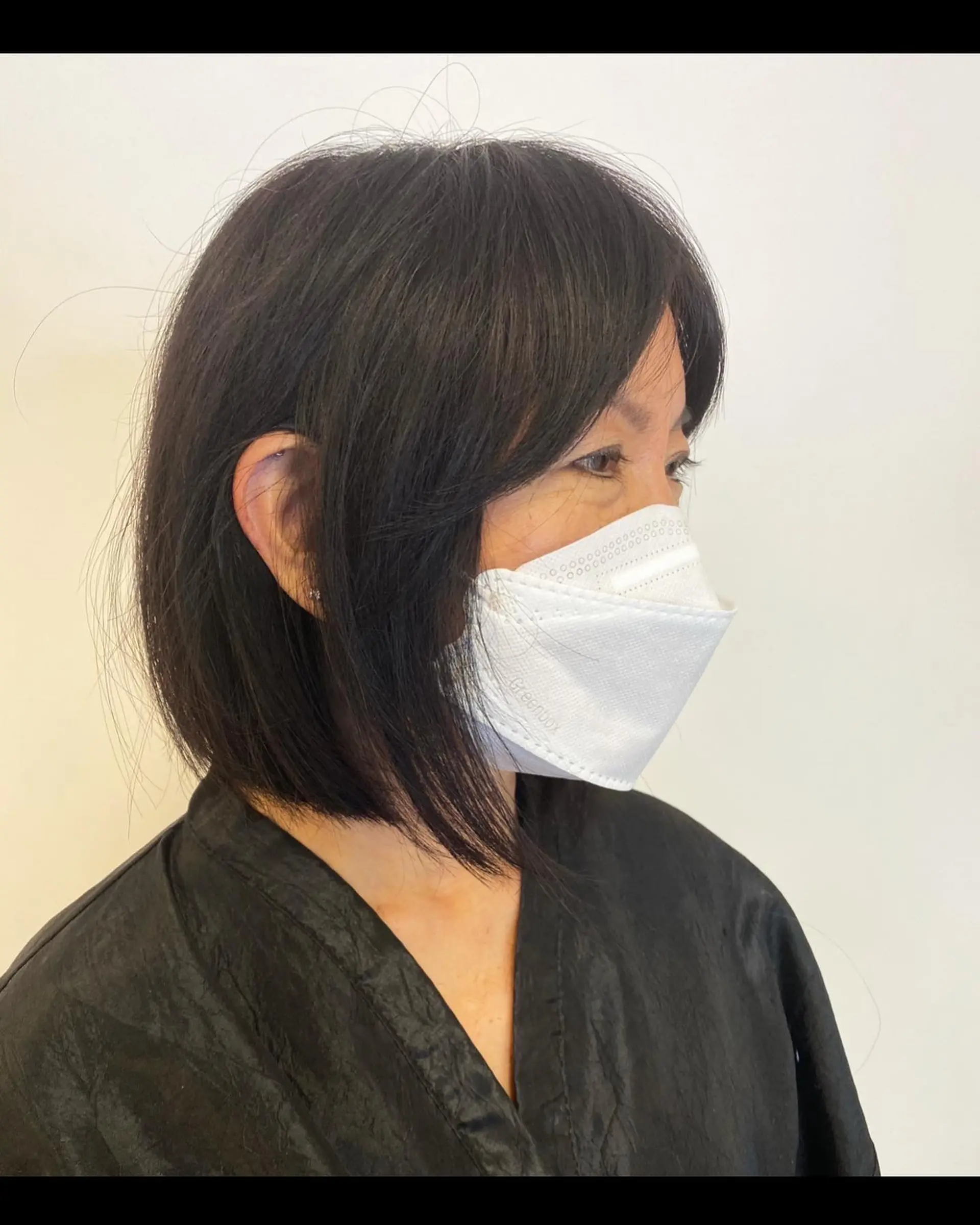 A sleek, short bob with delicate, wispy bangs. 1