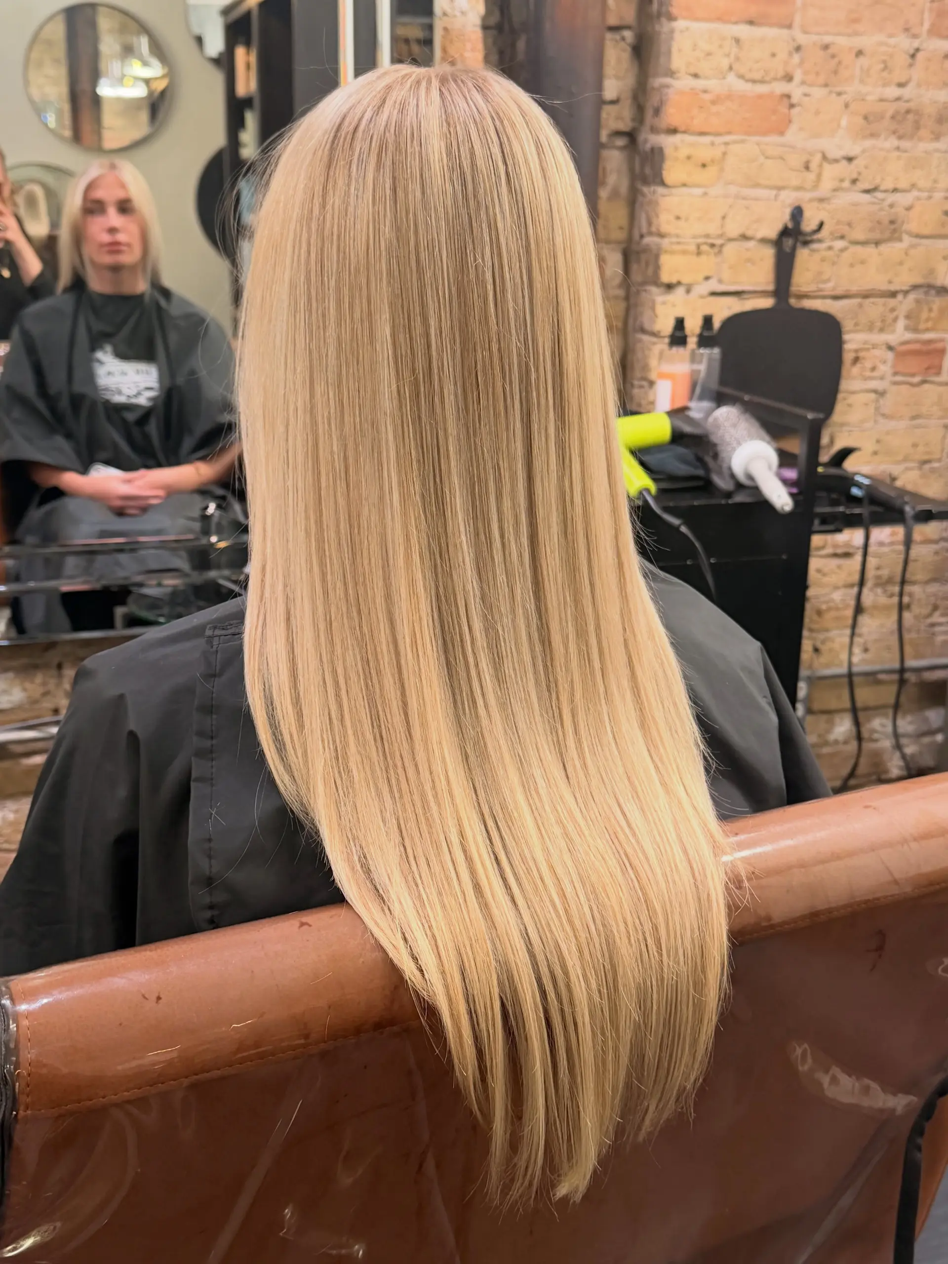 Long, sleek straight blonde hair with smooth texture falling down past the shoulders. 1