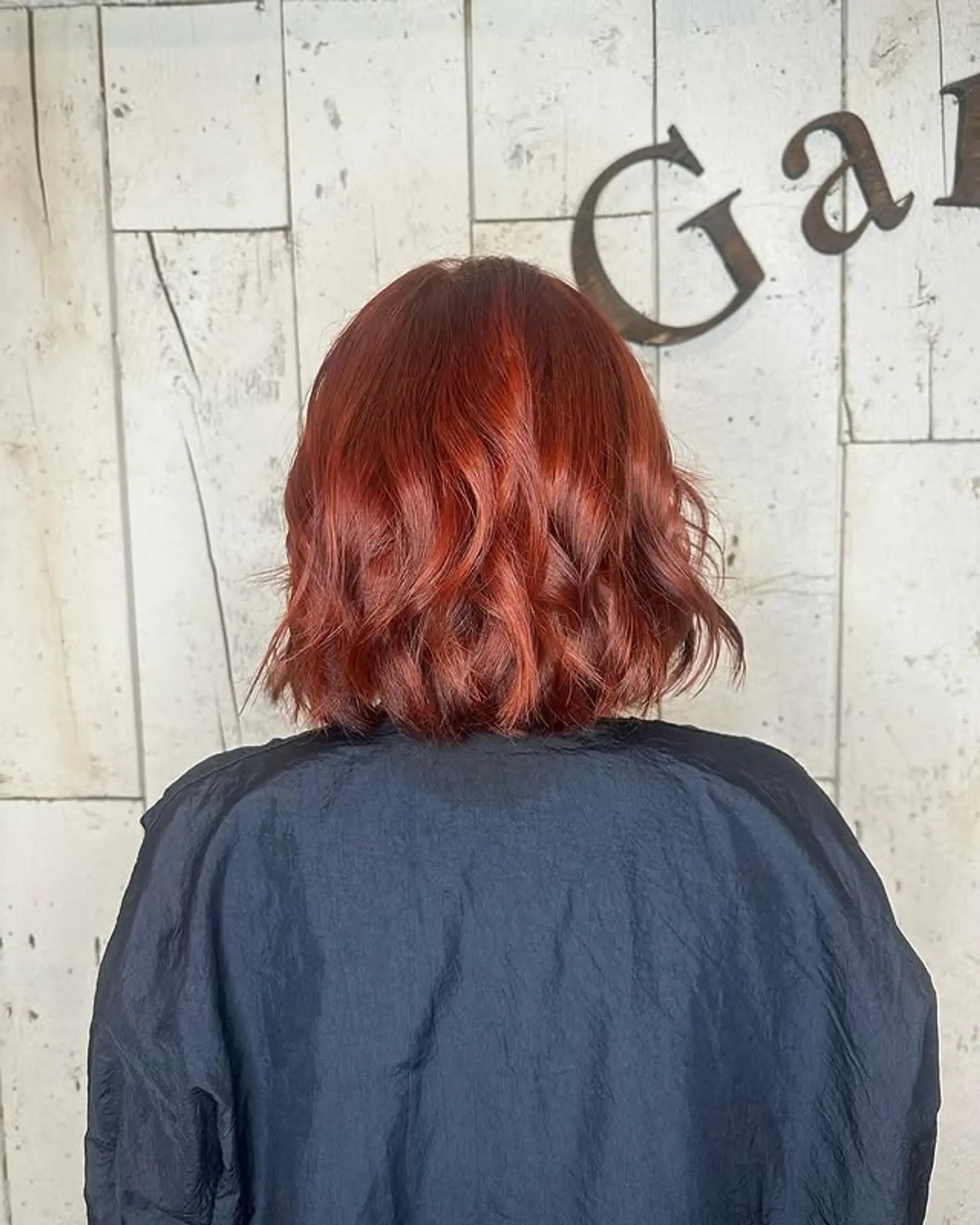A wavy bob with a blunt cut and vibrant copper and red tones. 1