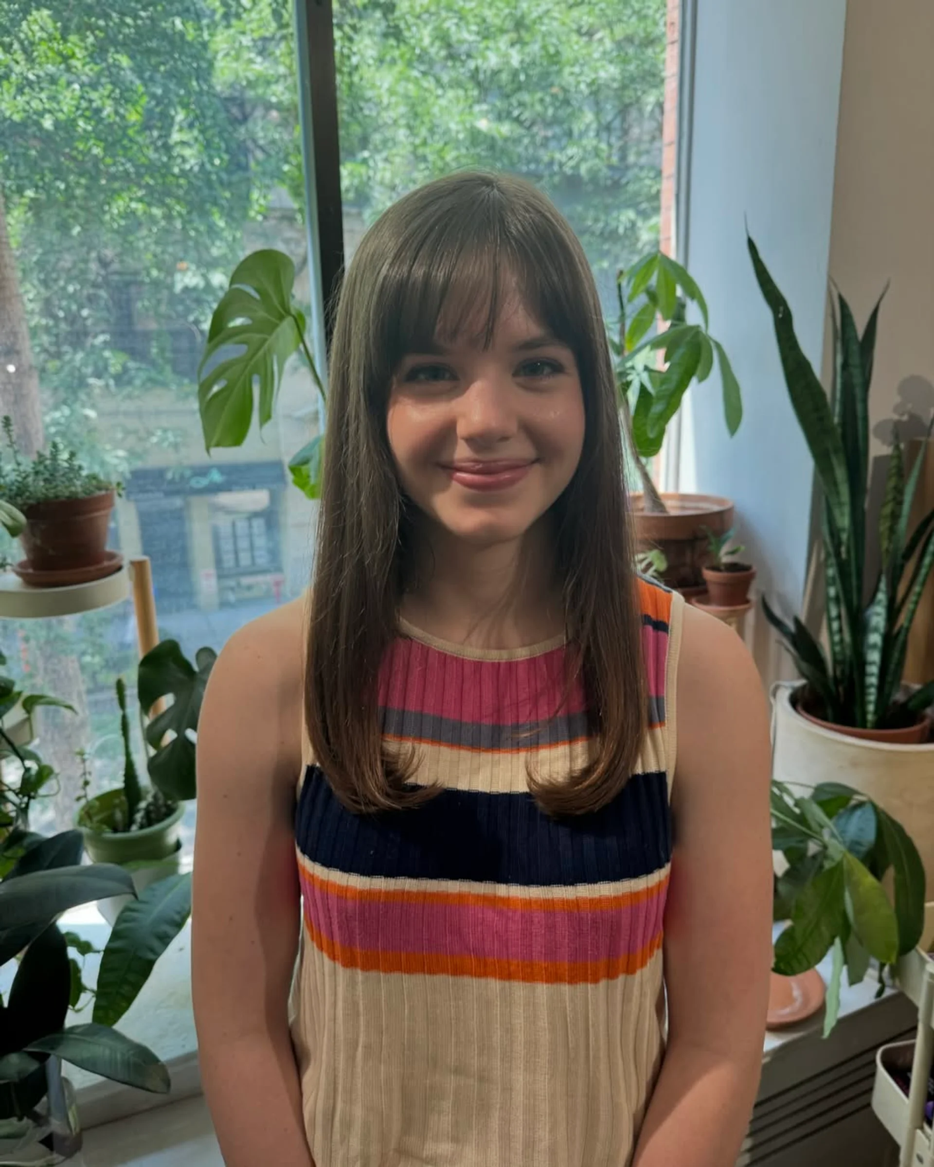 Trendy modern shag haircut with curtain bangs and textured layers in a New York City salon - Preview 3