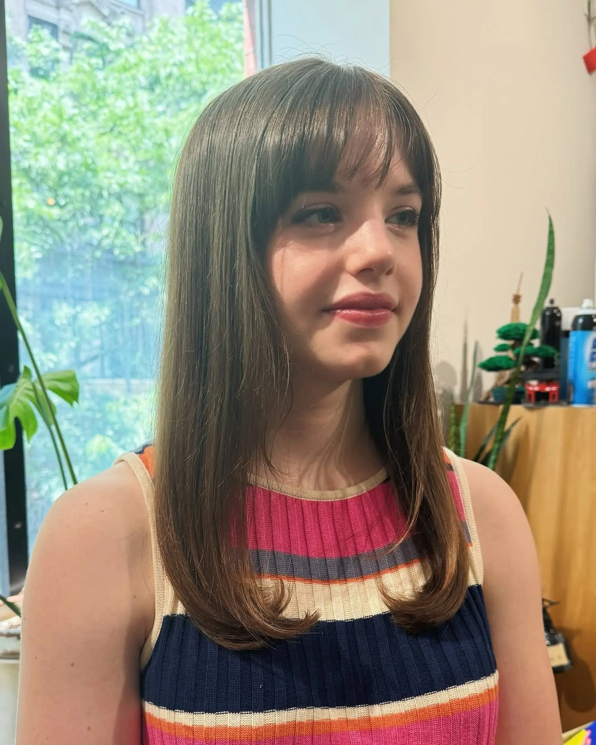 A shag haircut with curtain bangs and face-framing layers. 2