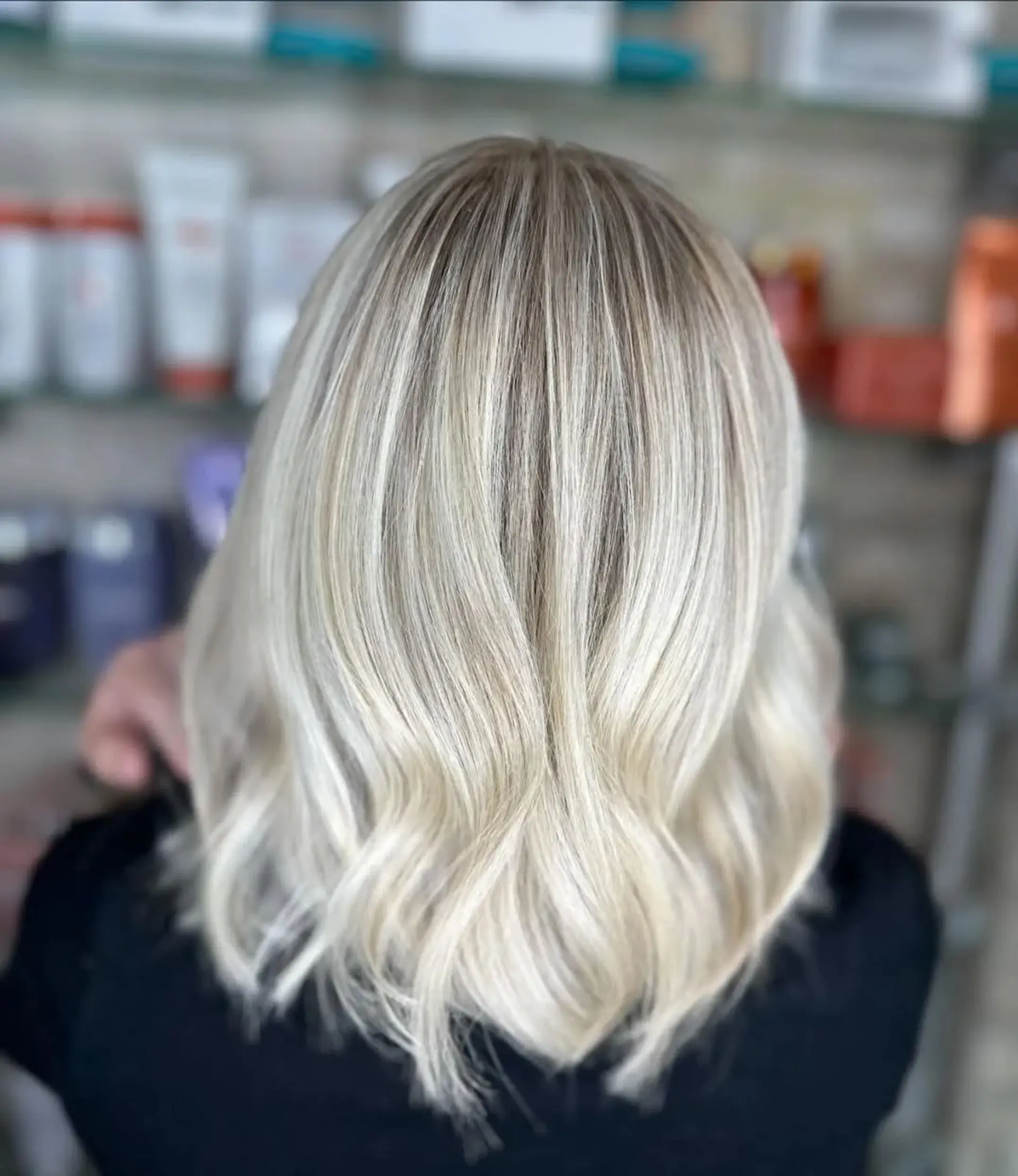This is a medium-length lob with a wavy finish and a balayage blonde coloring. 2