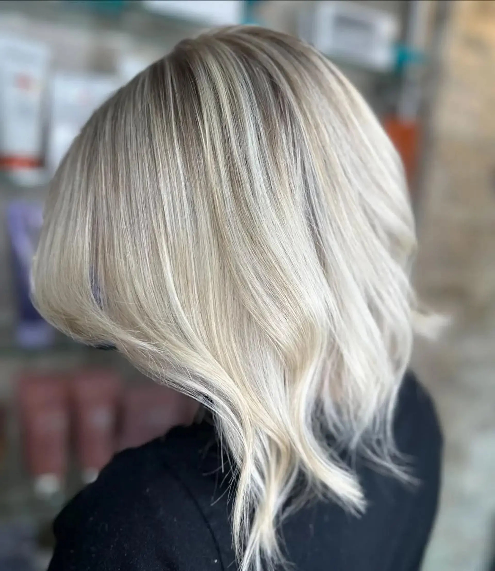 This is a medium-length lob with a wavy finish and a balayage blonde coloring. 3