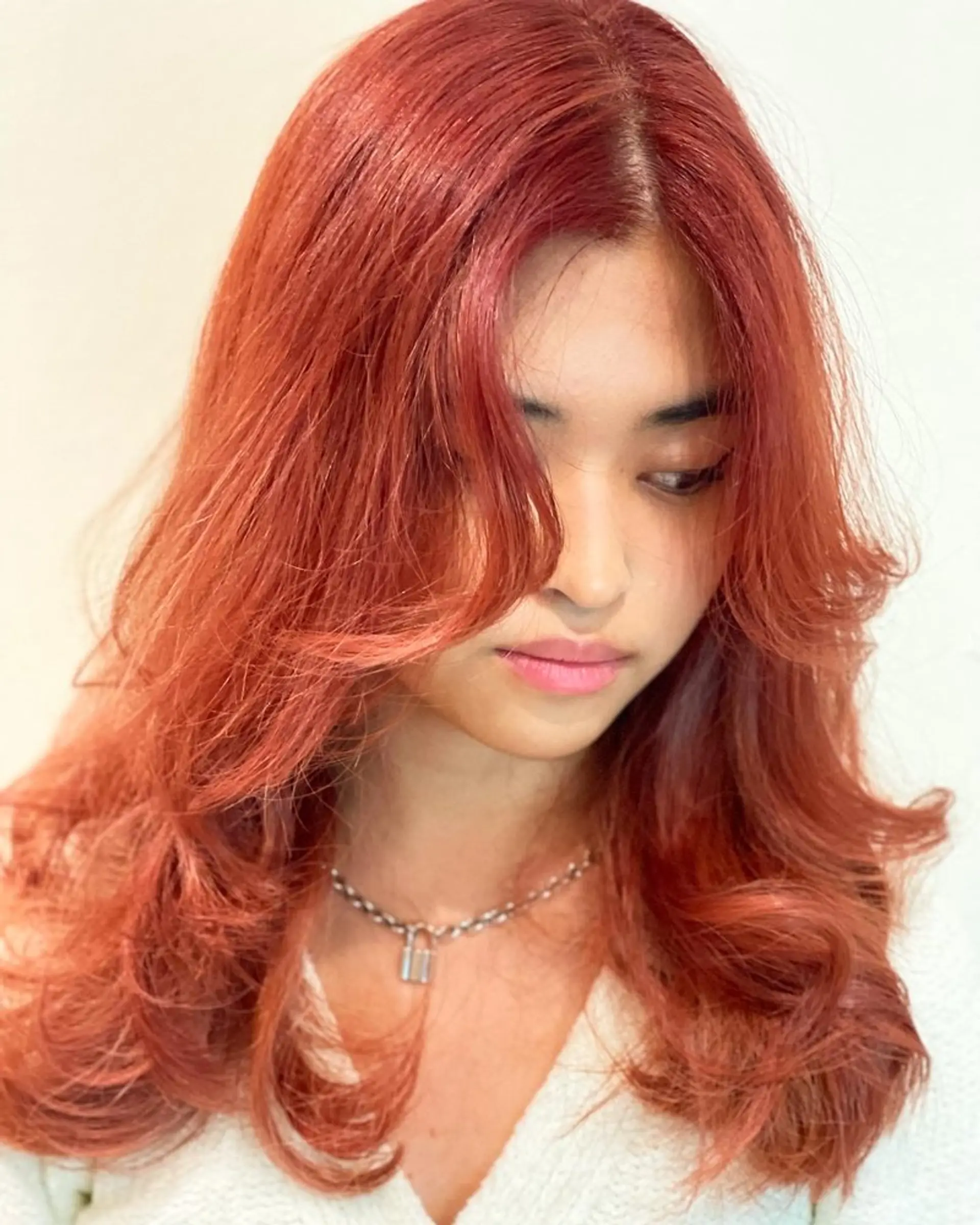 A medium-length layered haircut with face-framing layers. 1