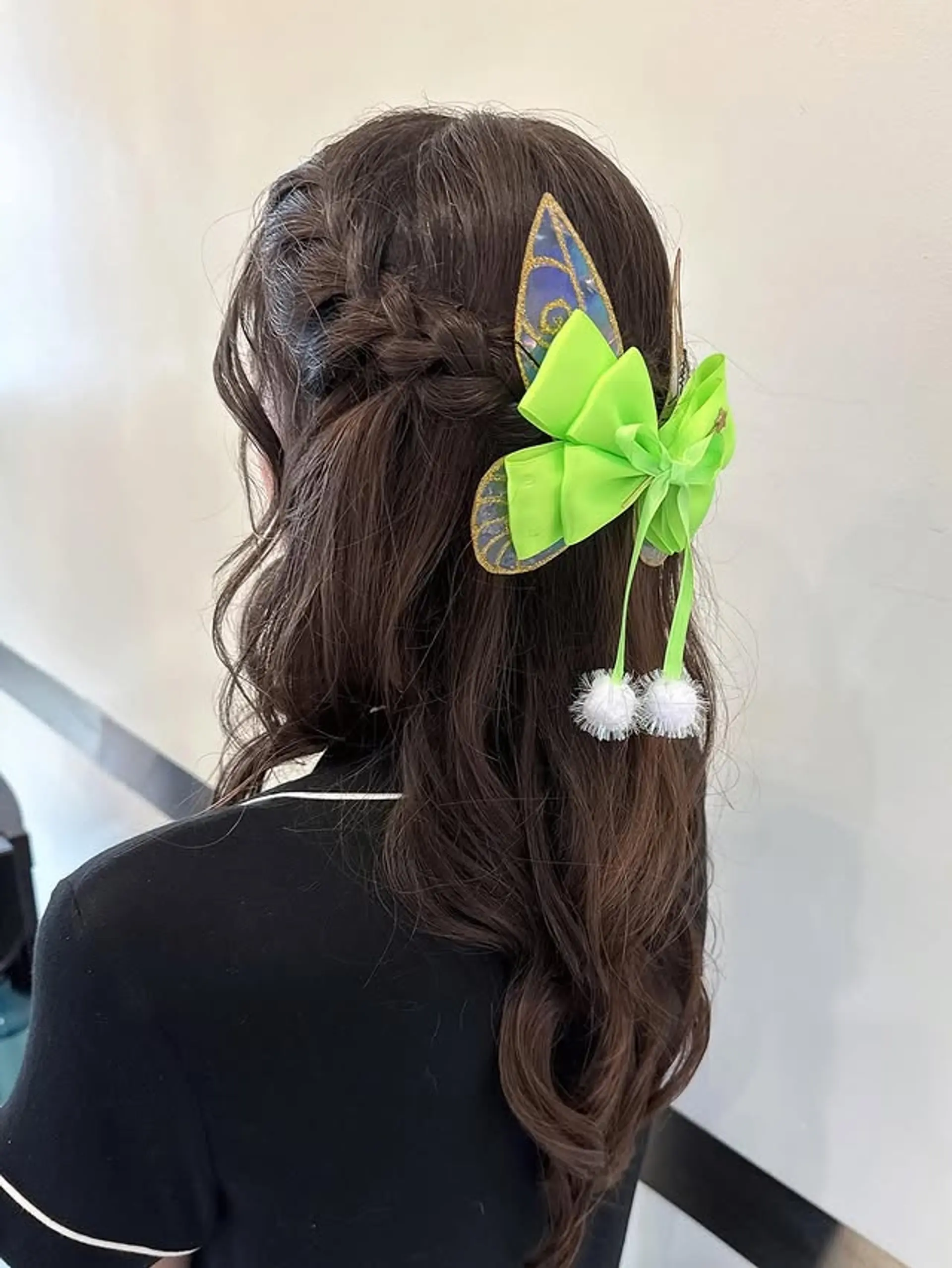 A long, wavy hairstyle with a braid and a green butterfly accessory. 1