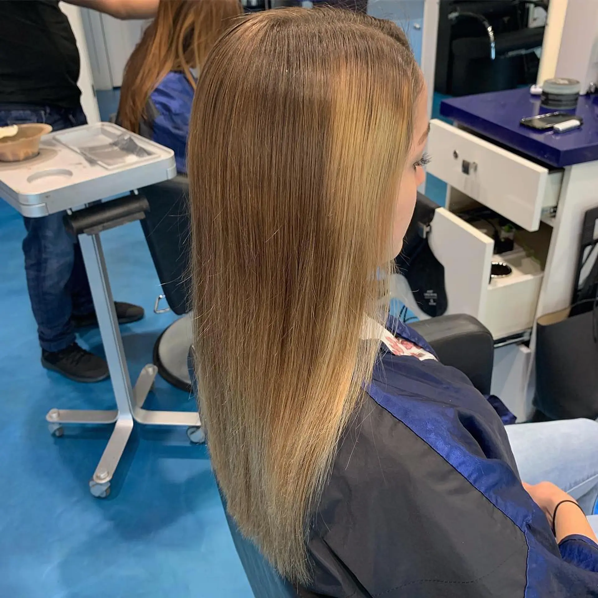 Long, straight blonde balayage with dark roots. 2