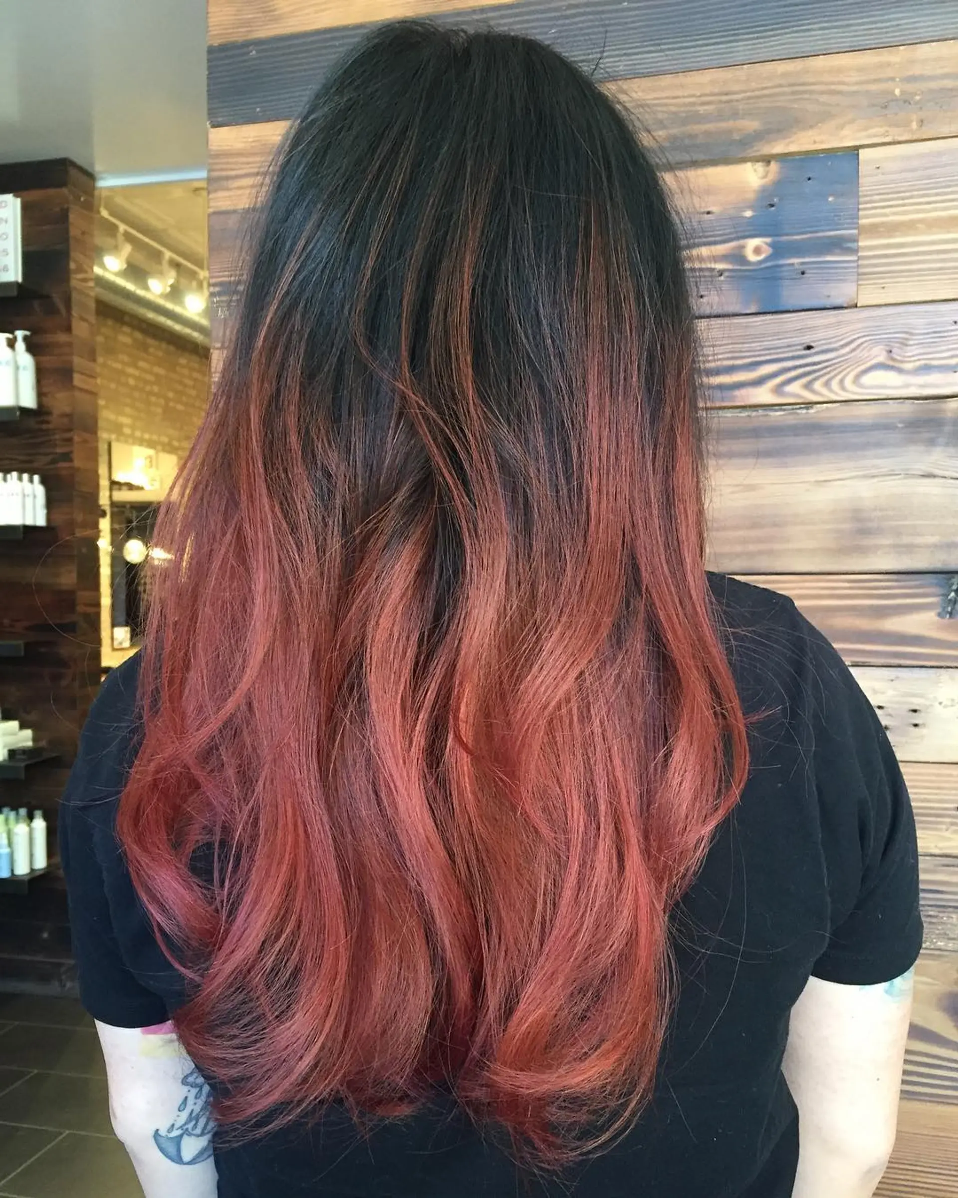 Long, layered hair with a black to copper ombre effect. 1