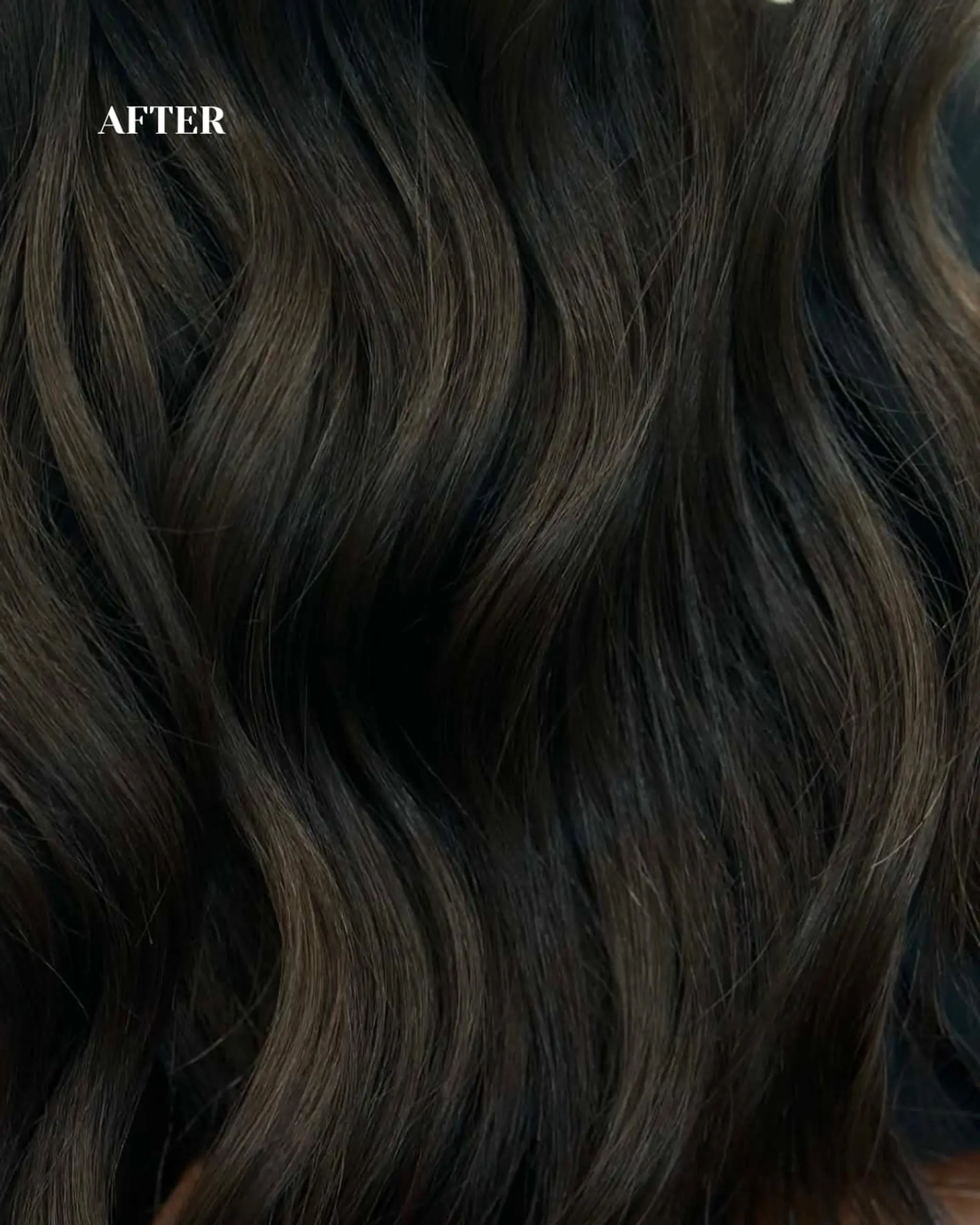 Lustrous dark brunette hair styled into rich, fluid natural waves with a healthy, glossy finish. 1