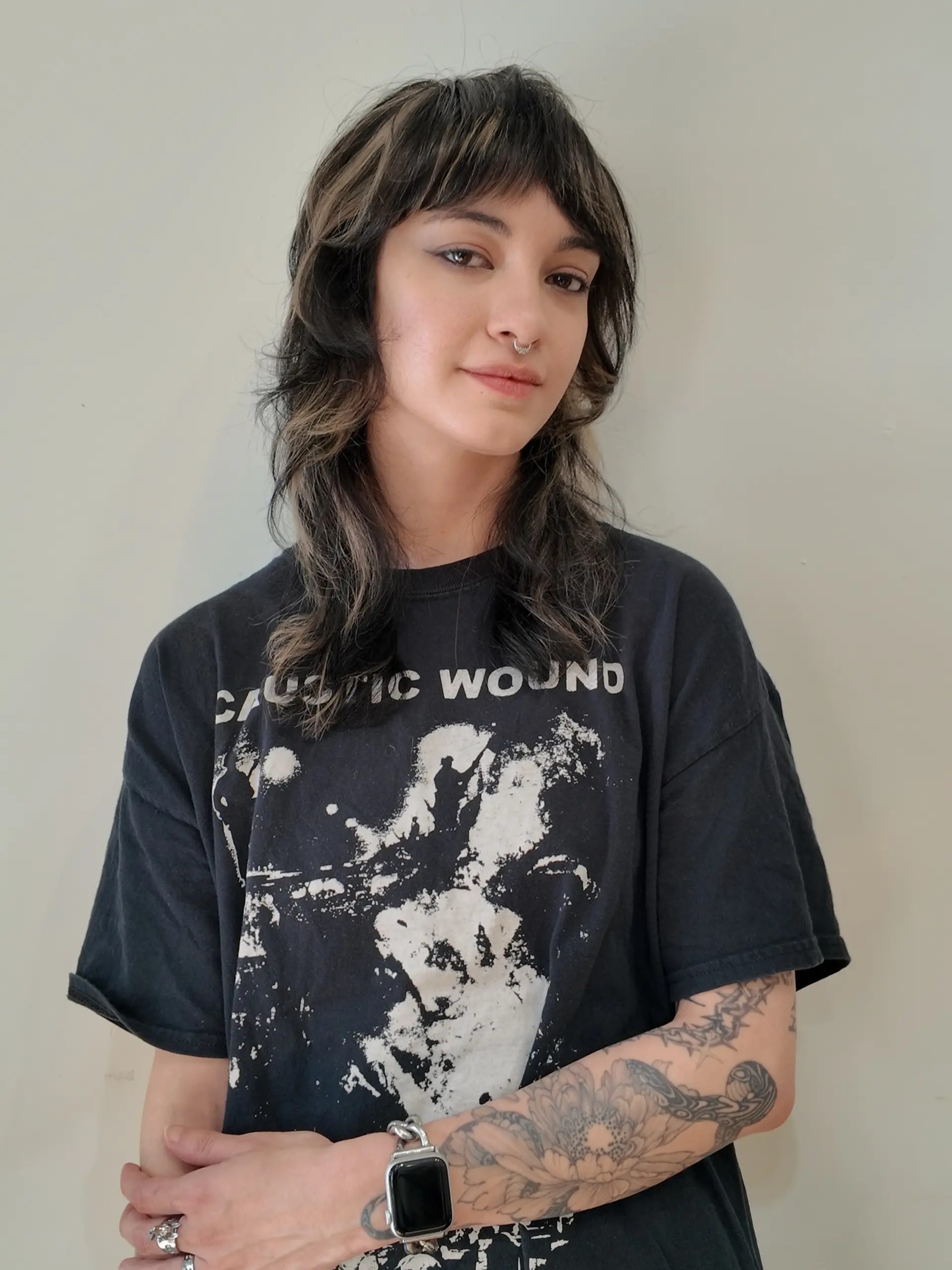 A textured medium-length shag haircut with soft face-framing layers, choppy bangs, and contrasting chunky highlights. 1