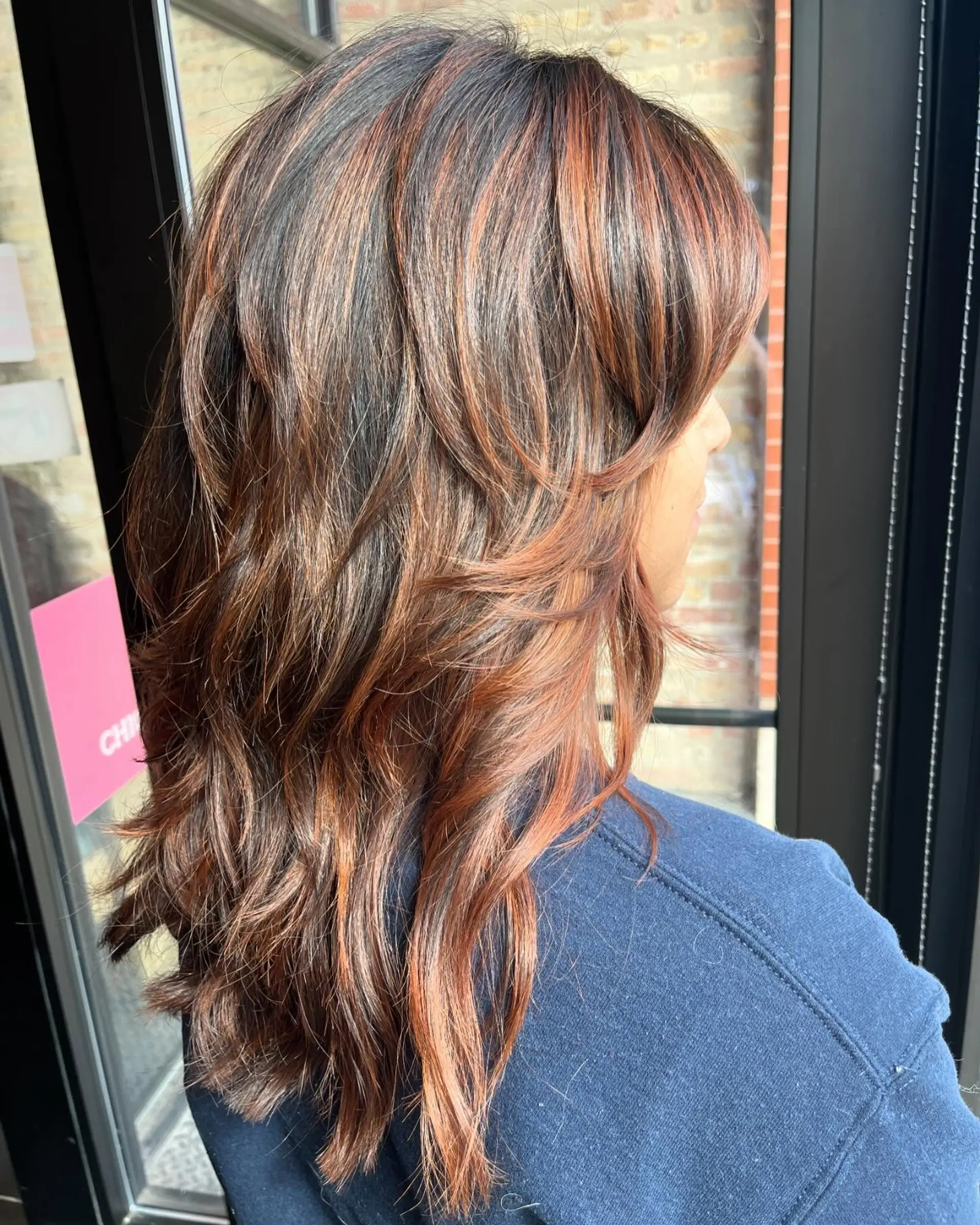 Long, layered wavy hair with copper highlights on a bronde base. 1