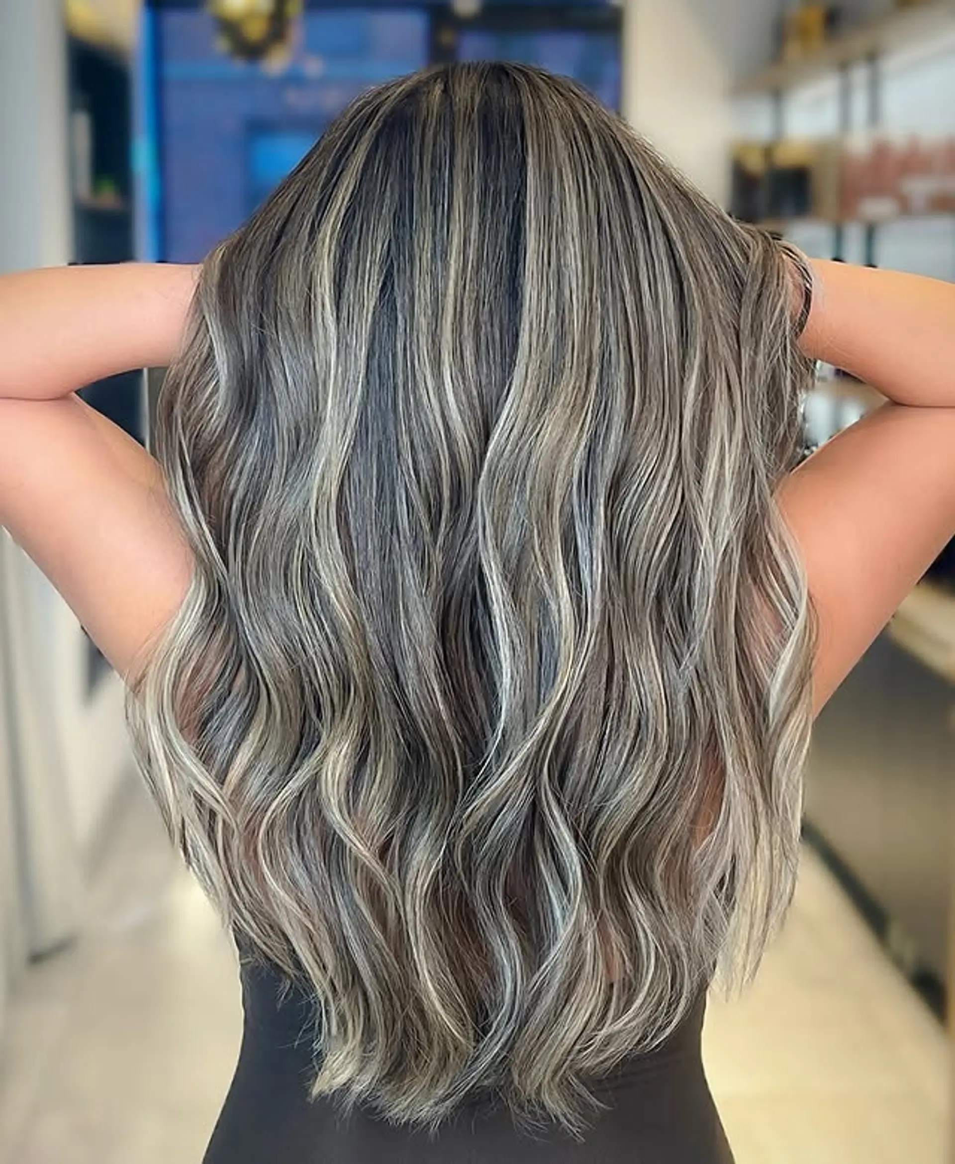 Long wavy hair with a blended ash blonde balayage. 1