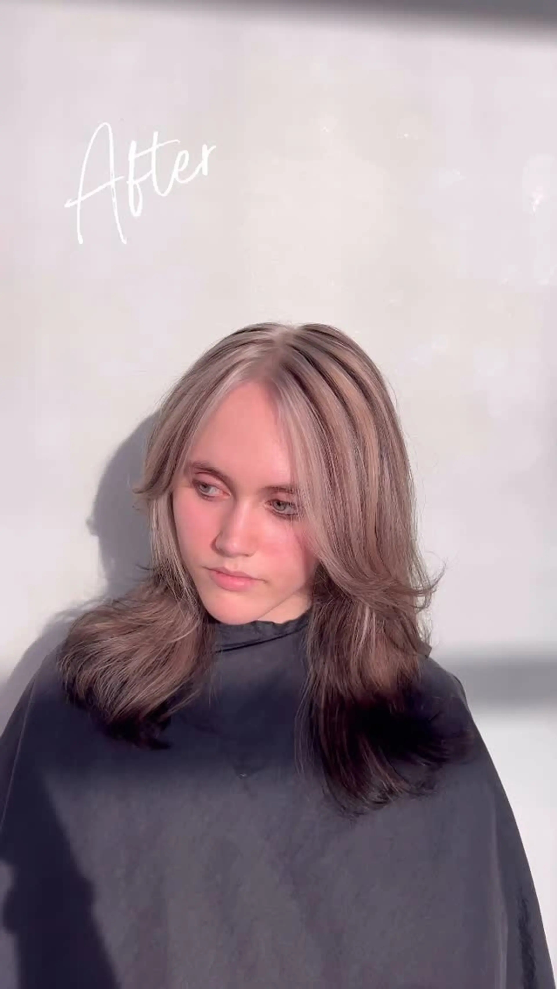 Long layered haircut featuring high-contrast chunky blonde highlights over dark brown hair, styled with face-framing curtain bangs. 1