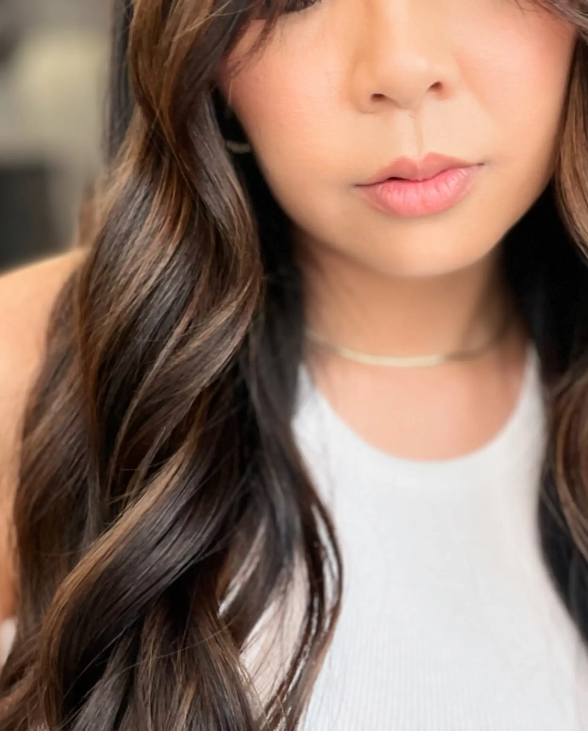 Long chocolate brown hair styled into soft, defined waves featuring subtle dimensional highlights. 1