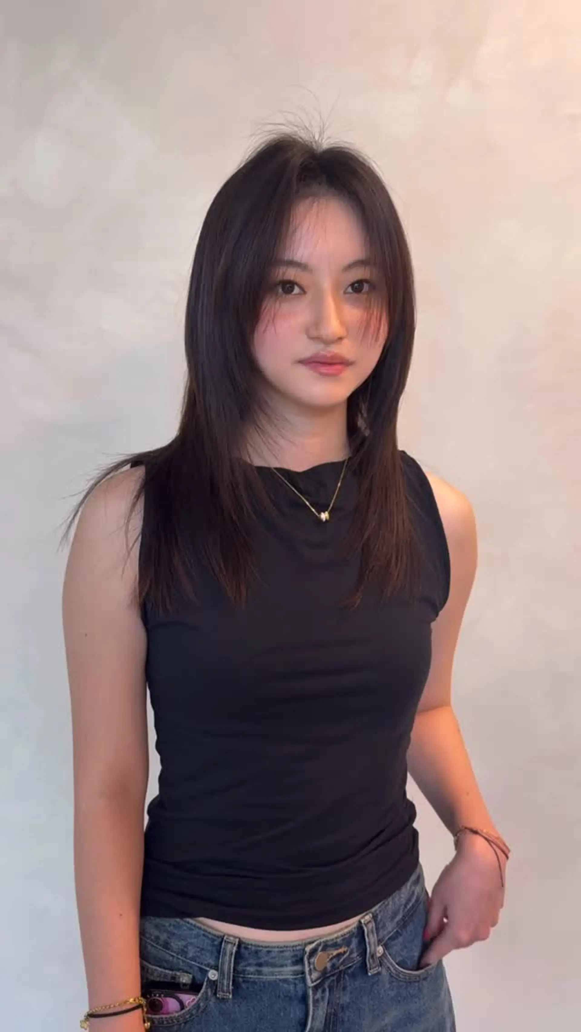 Medium-length straight dark hair featuring feathered face-framing layers and soft, parted wispy bangs. 1