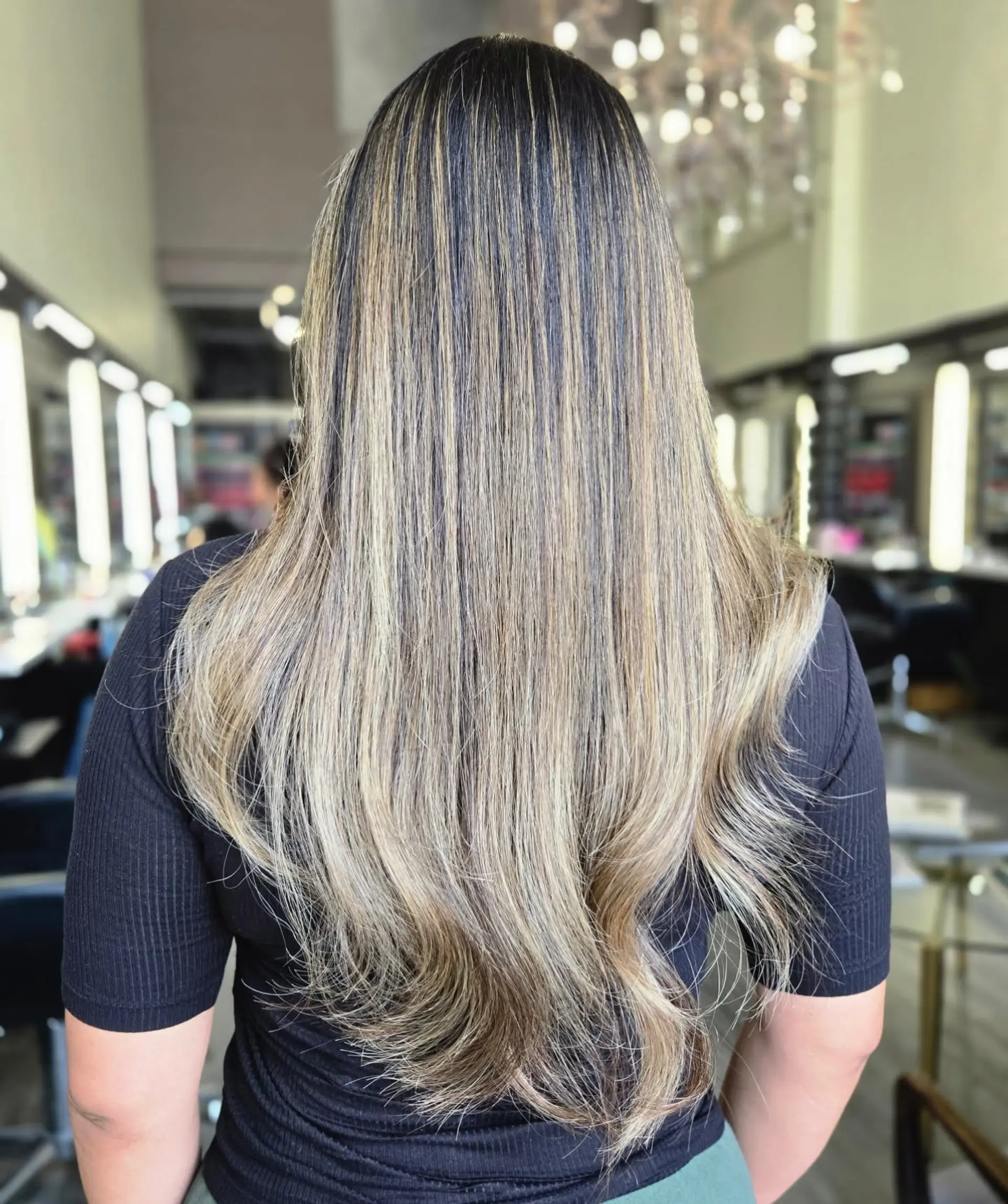 Long, smooth hair featuring full dimensional blonde highlights over a dark base with softly layered ends. 1