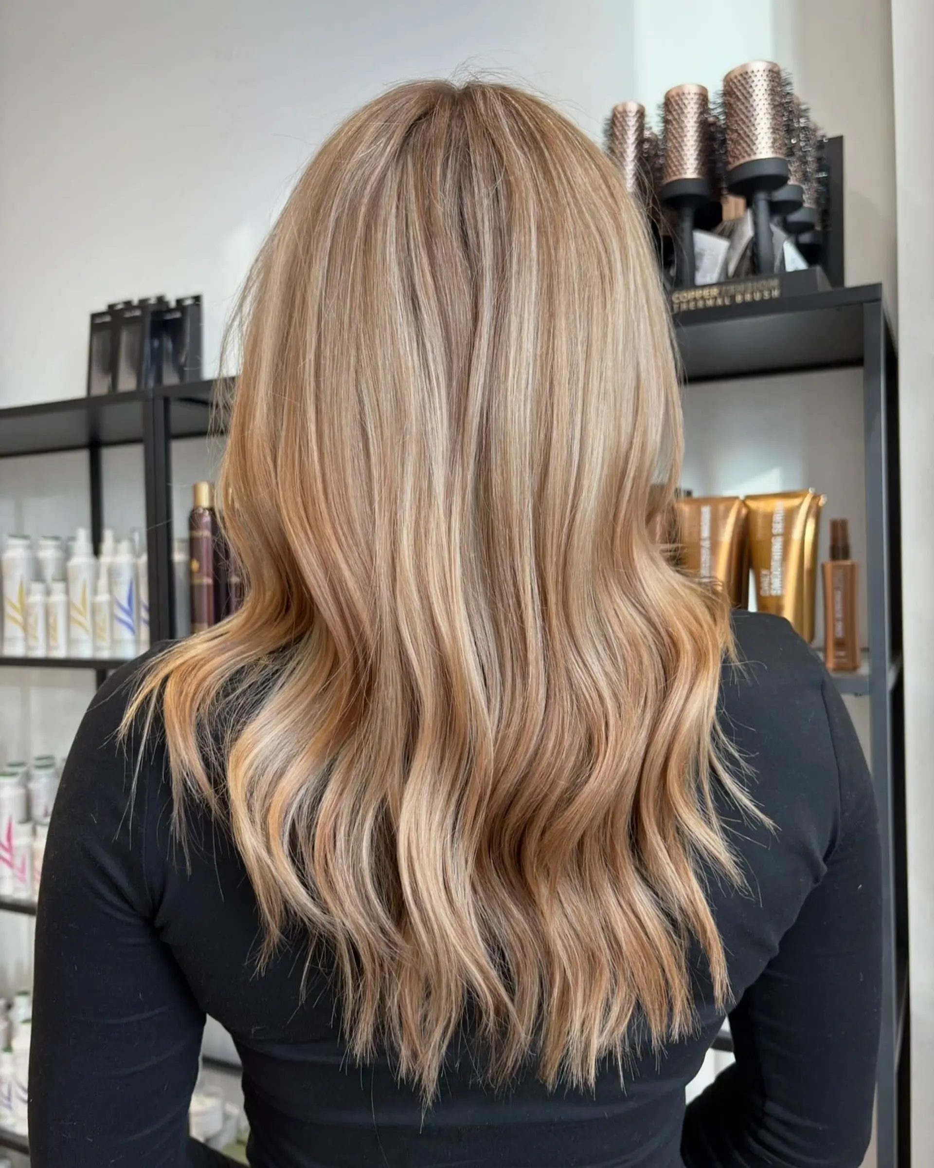 Long dimensional blonde hair styled with soft, natural-looking waves throughout the lengths. 1
