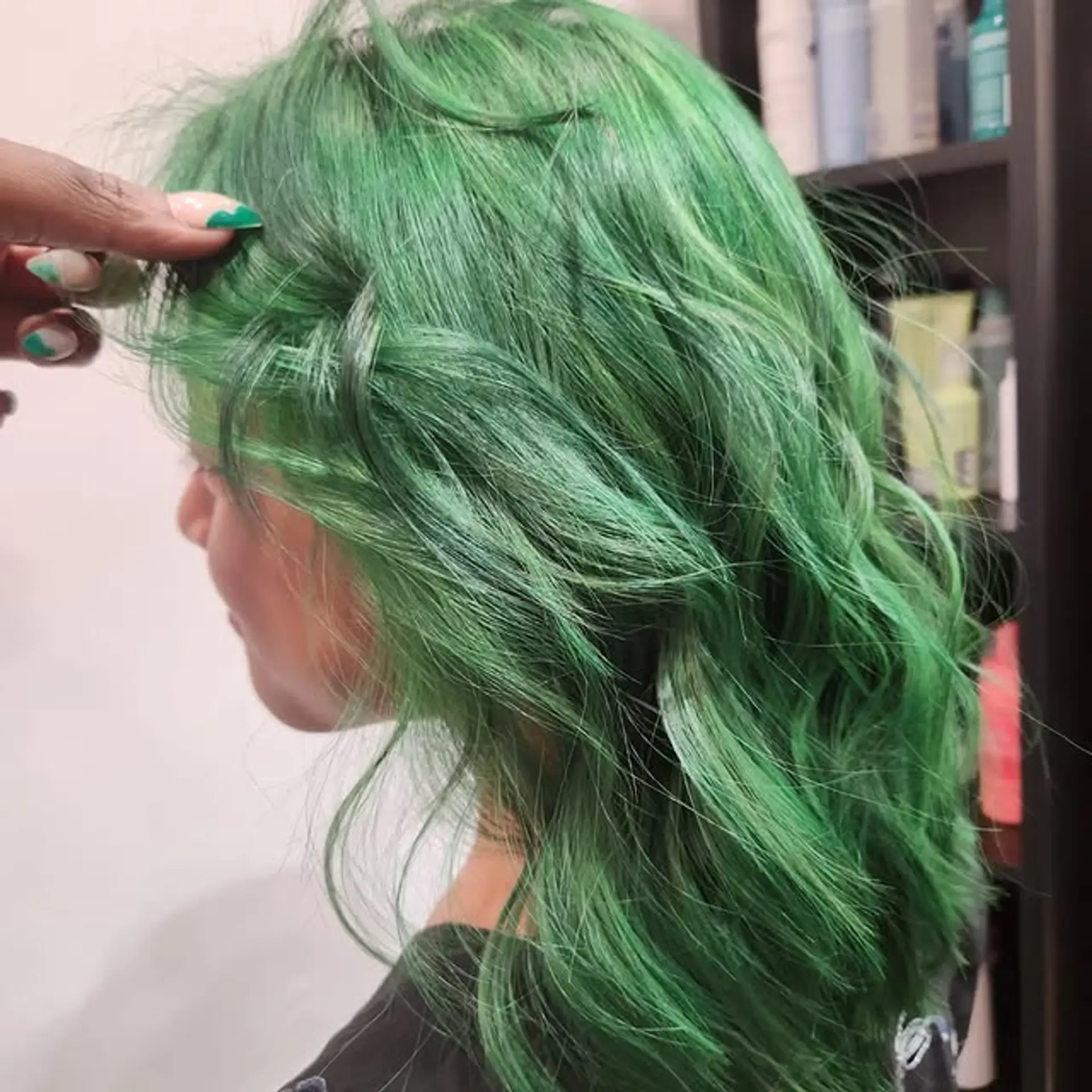A medium-length wavy hairstyle dyed a vibrant green. 1