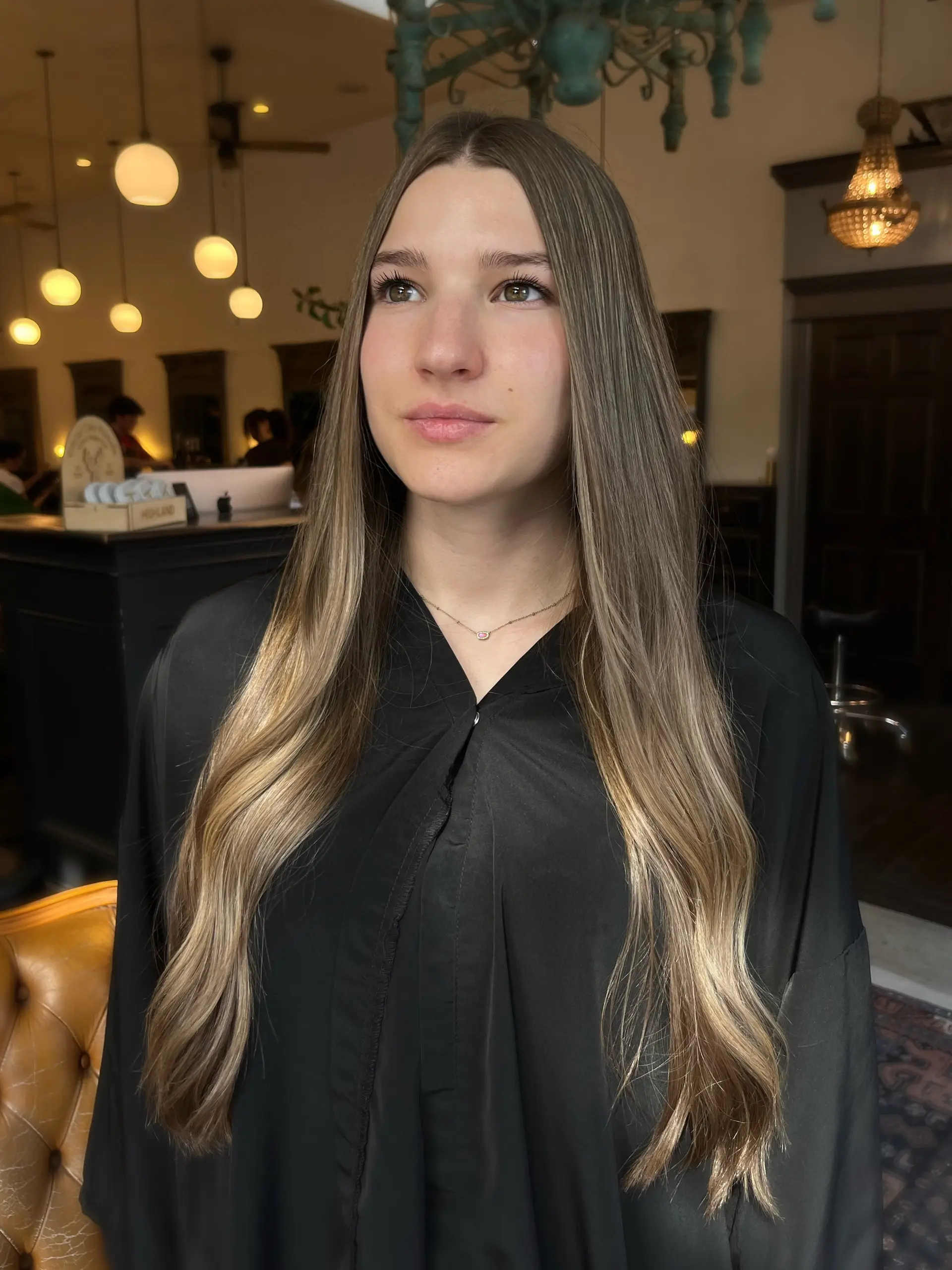 Extra-long hair styled with a center part and soft bends, showcasing finely blended golden blonde highlights over a light brown base. 1