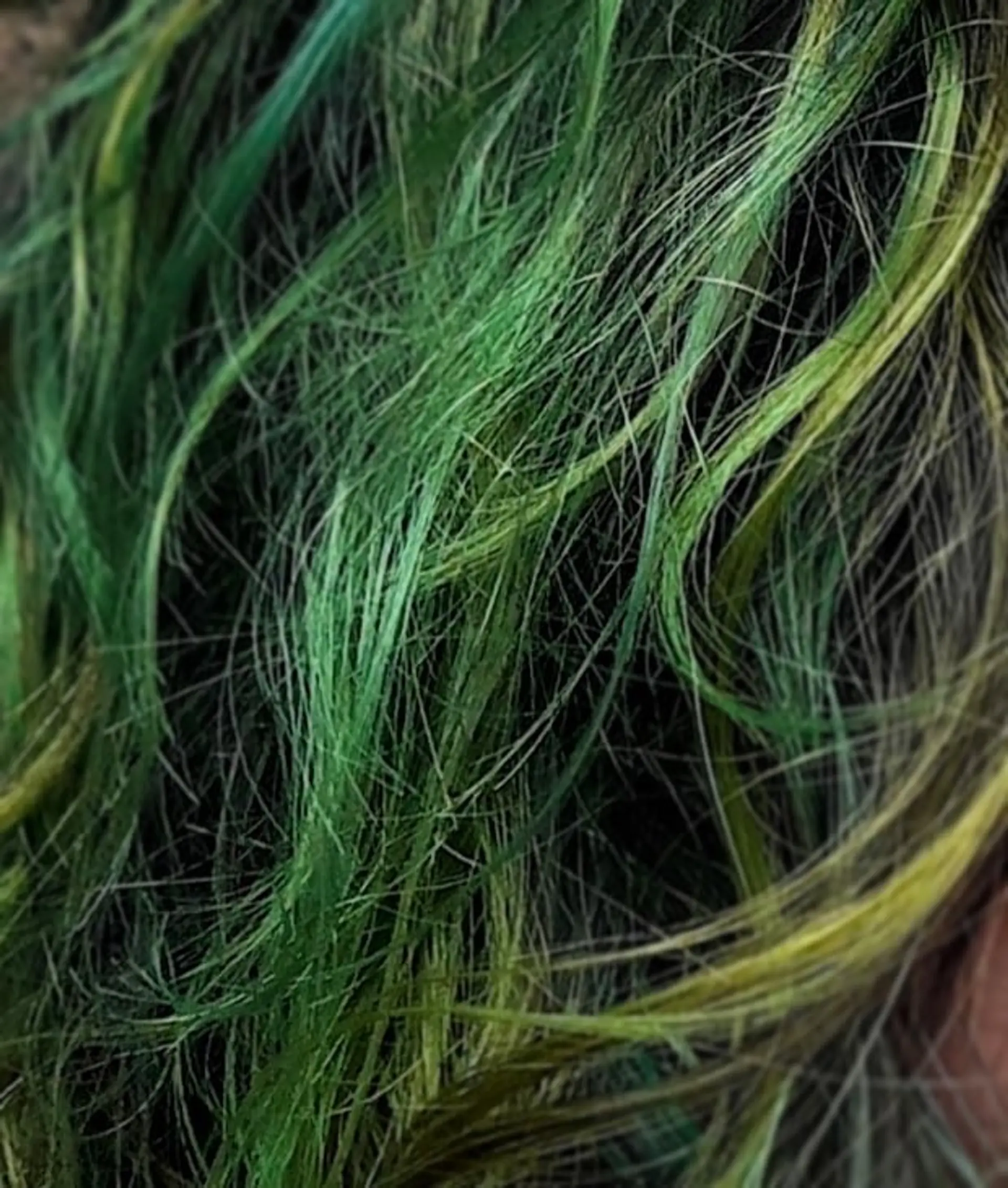 A vibrant ombre effect with shades of green and yellow, styled into loose waves. 1