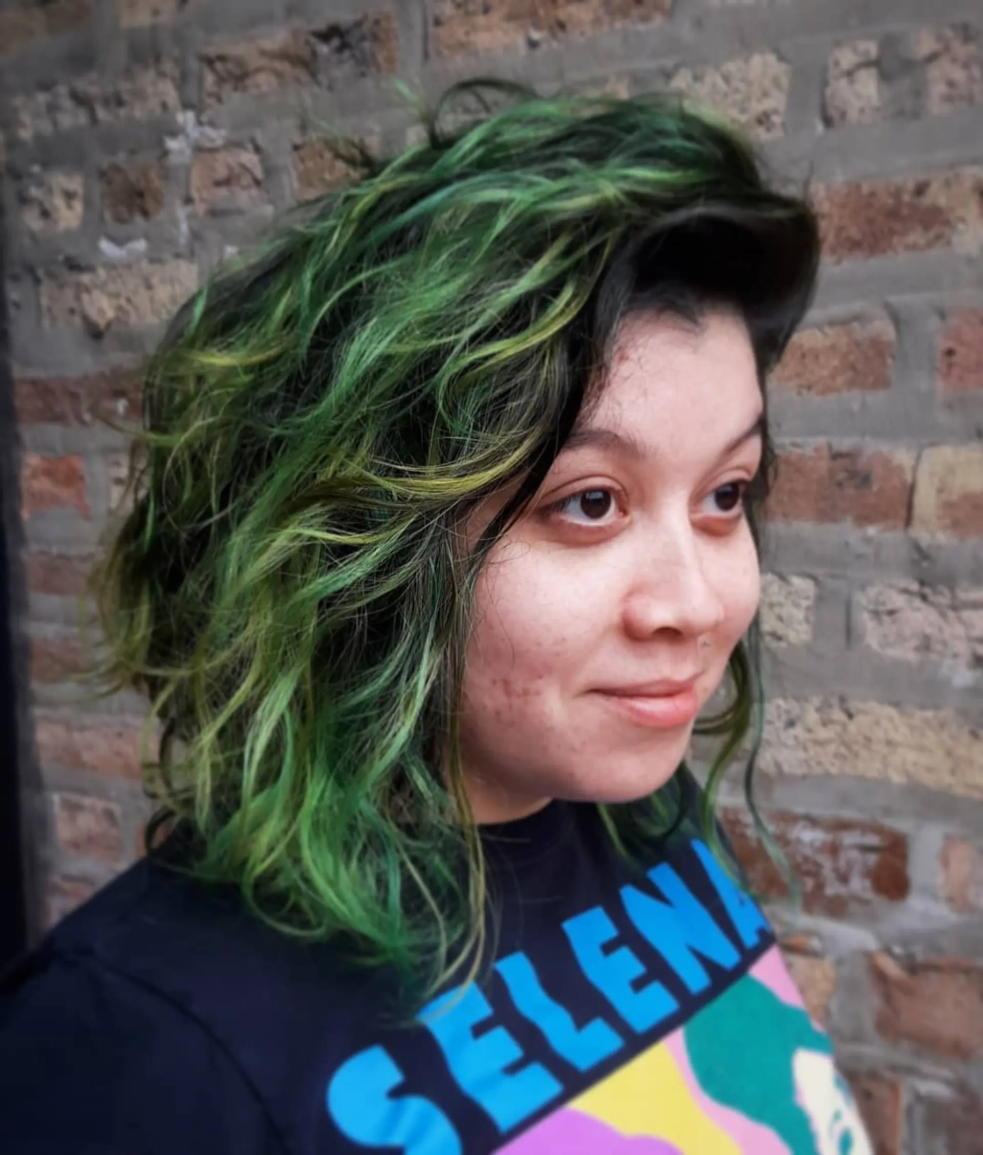A vibrant ombre effect with shades of green and yellow, styled into loose waves. 2