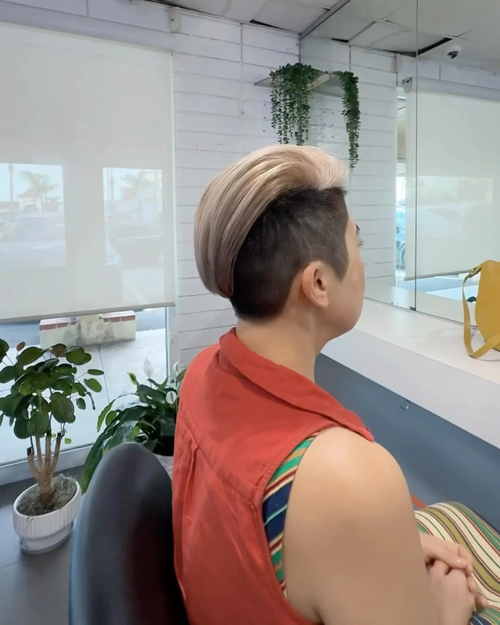 A side-swept undercut featuring clean, short-clipped sides paired with a smooth, longer top brushed back and to the side. 1