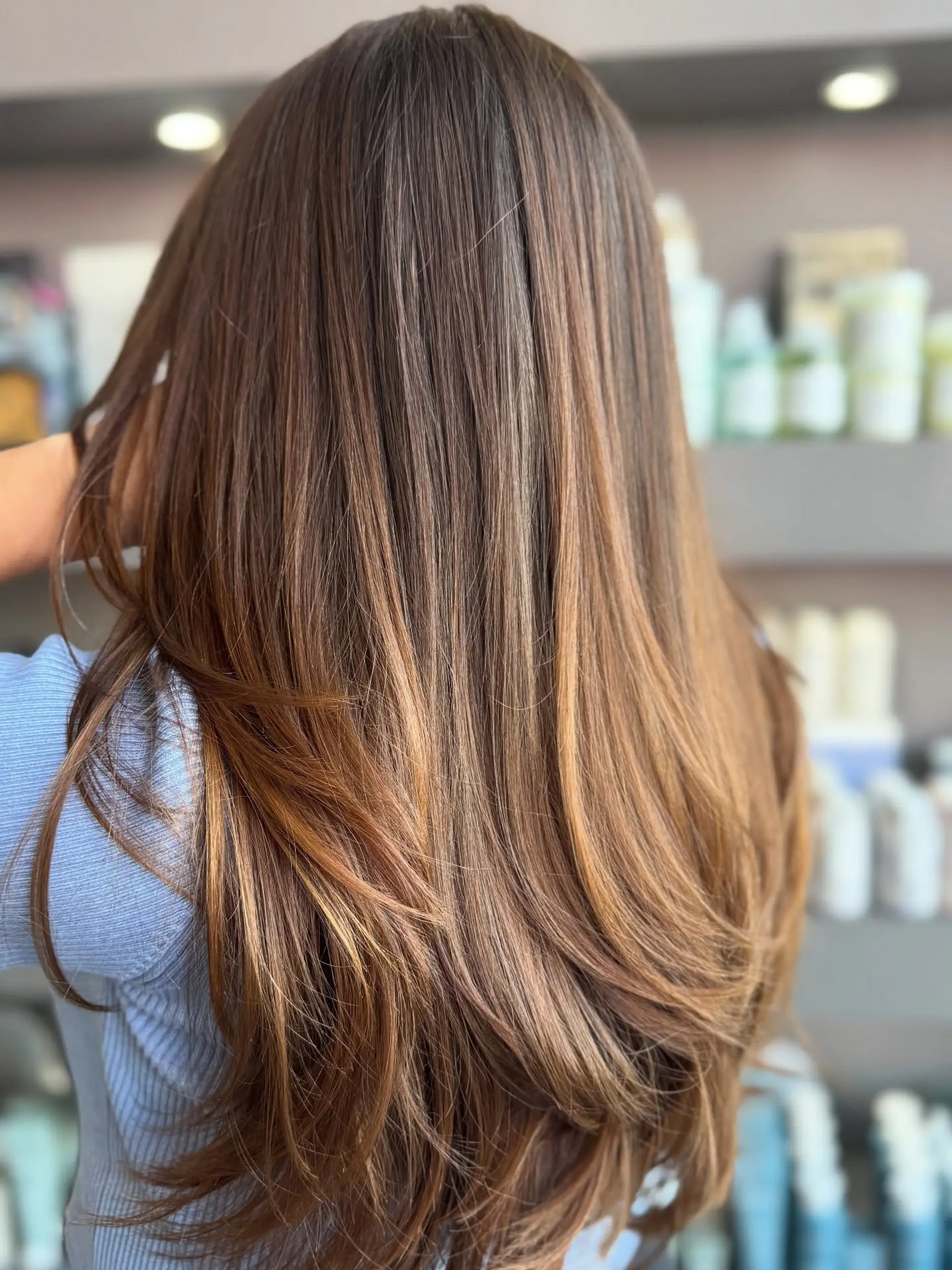 Long straight brunette hair cut with soft blended layers and styled with smooth, rounded ends. 1