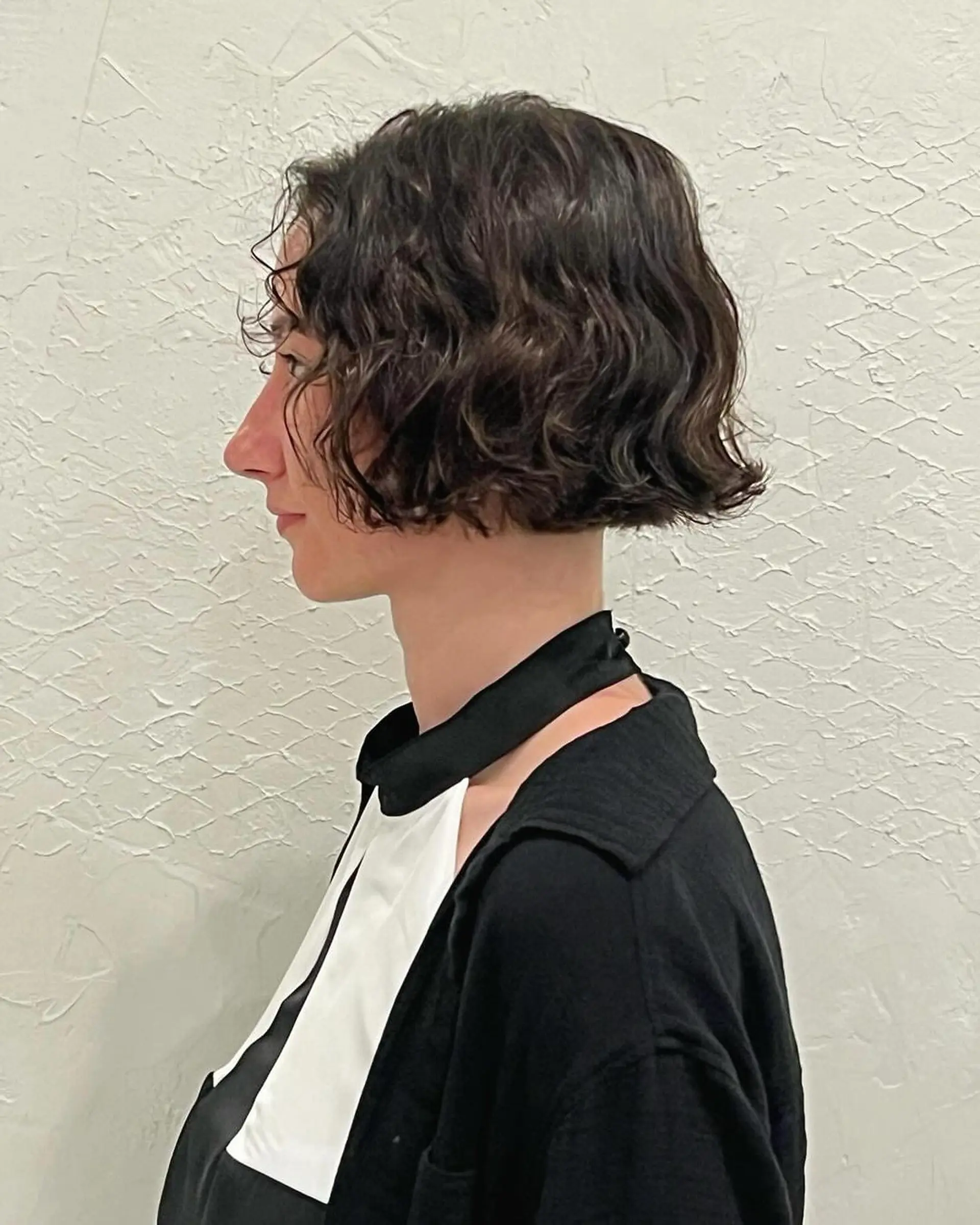 Short, wavy bob with dark brown waves that adds a casual yet elegant look. 1