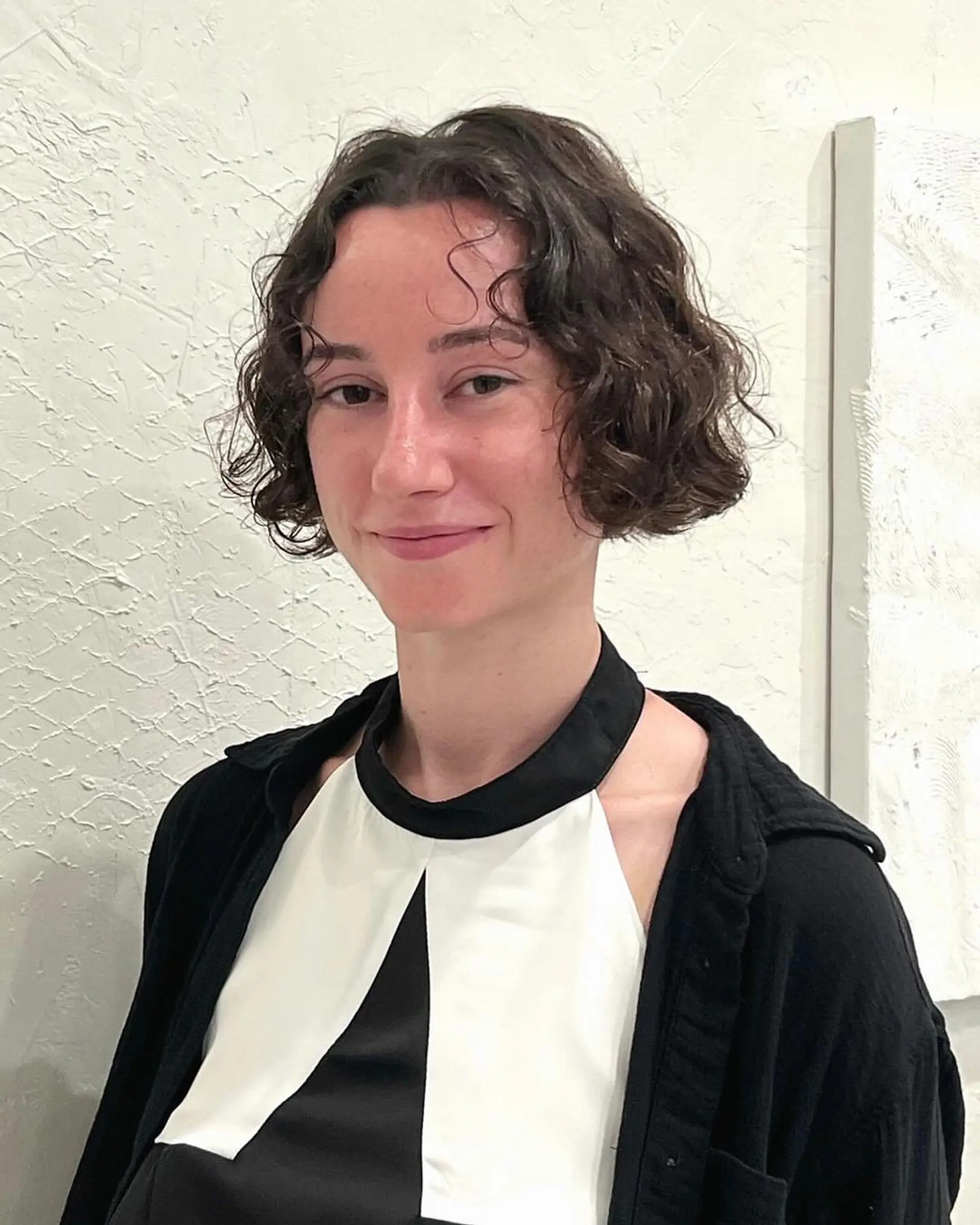 Short, wavy bob with dark brown waves that adds a casual yet elegant look. 2