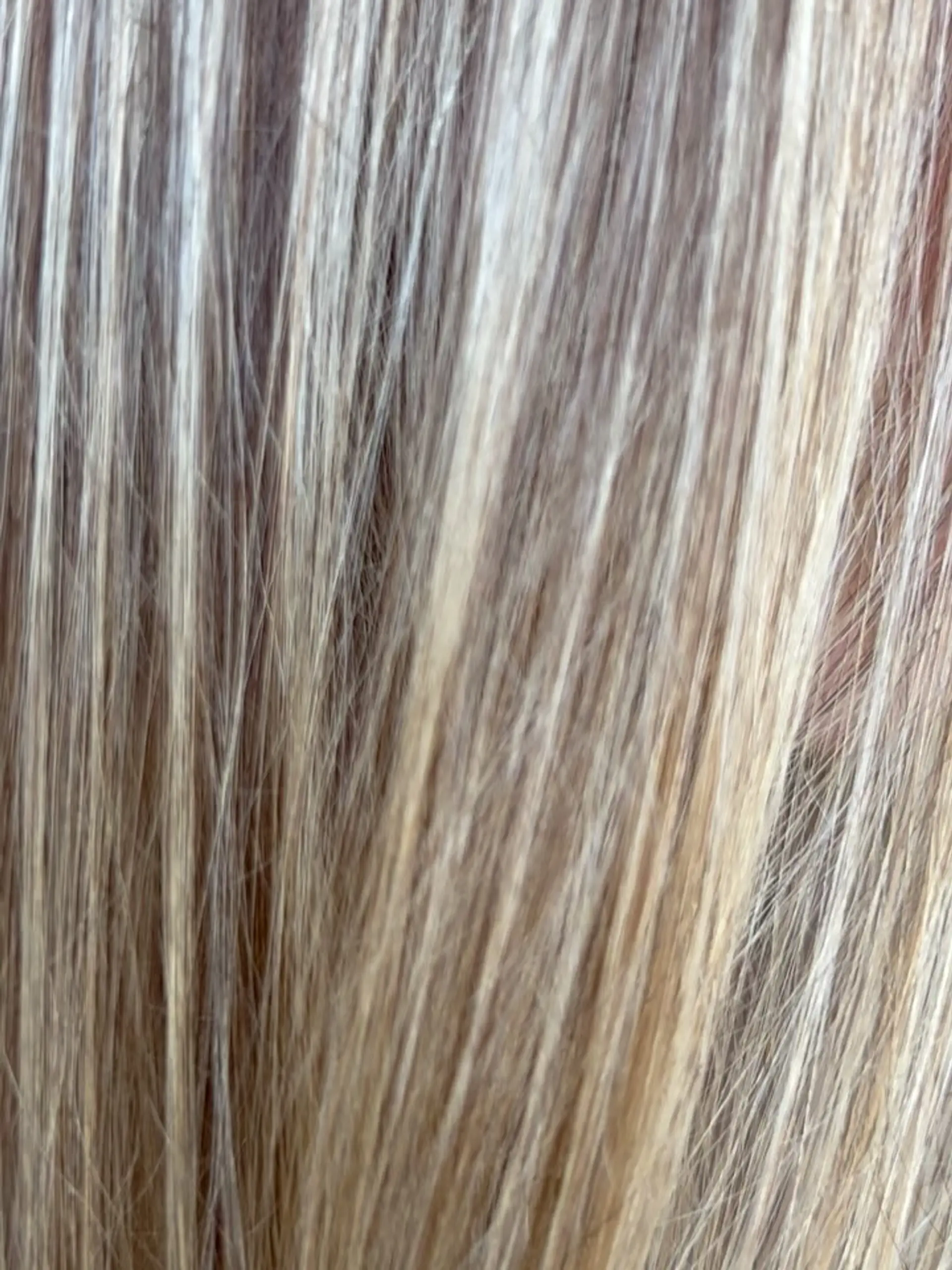 A close-up shot of straight hair featuring blended blonde highlights and subtle lowlights. 1