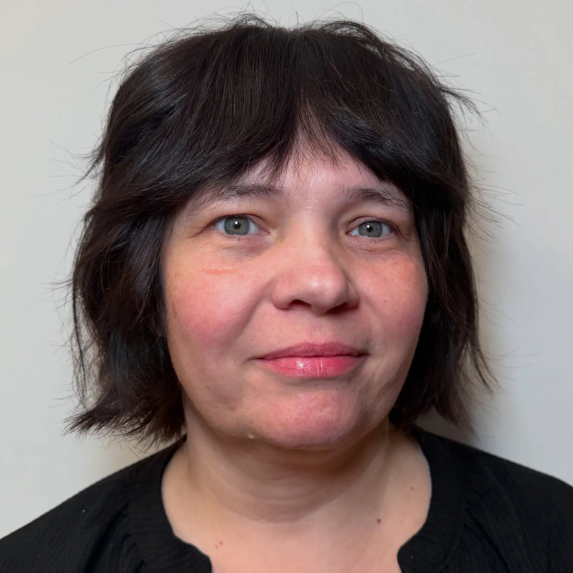 A short, piecey textured bob featuring soft, full bangs. 1