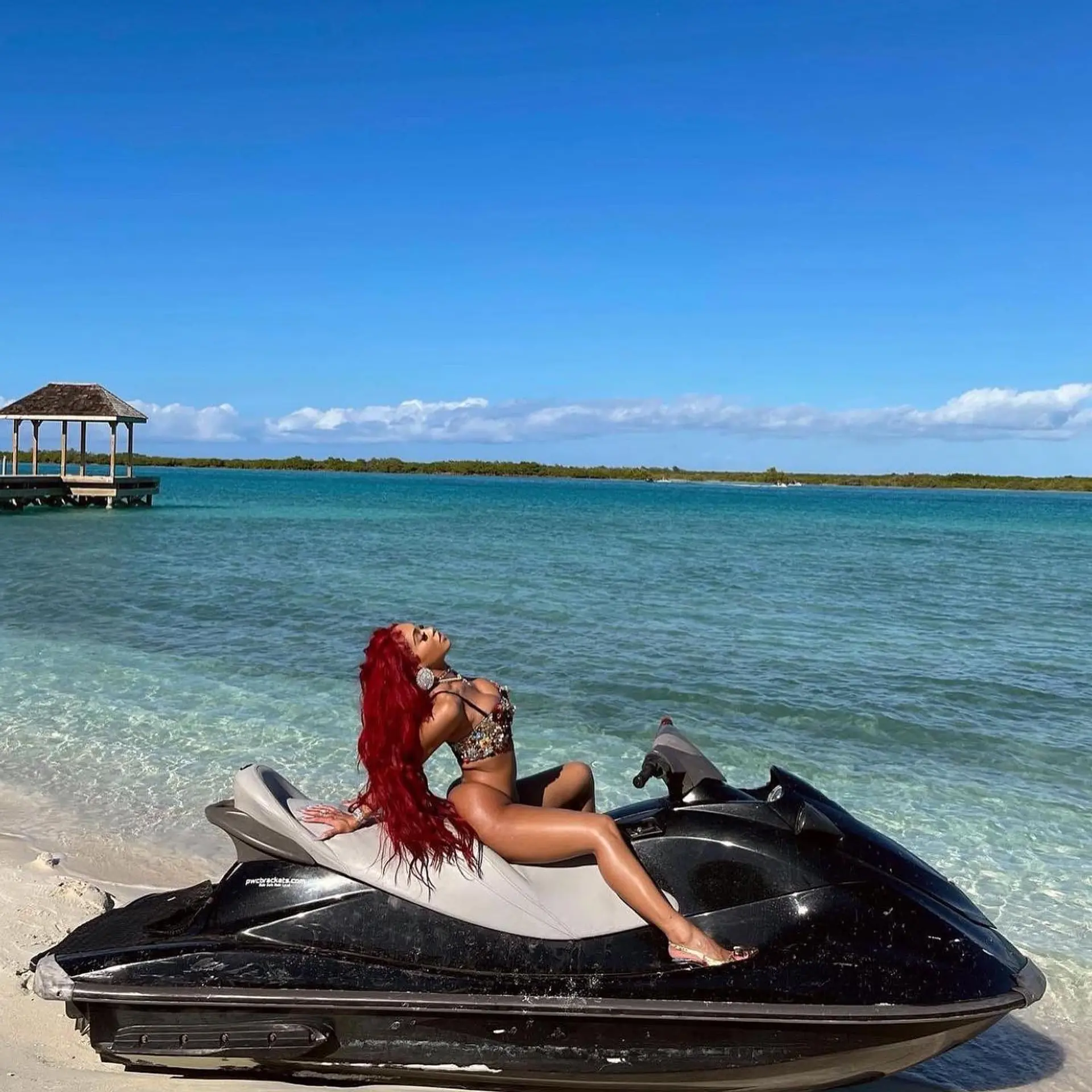 Ultra-long, vibrant cherry red hair cascading down the back in loose, beachy waves. 1
