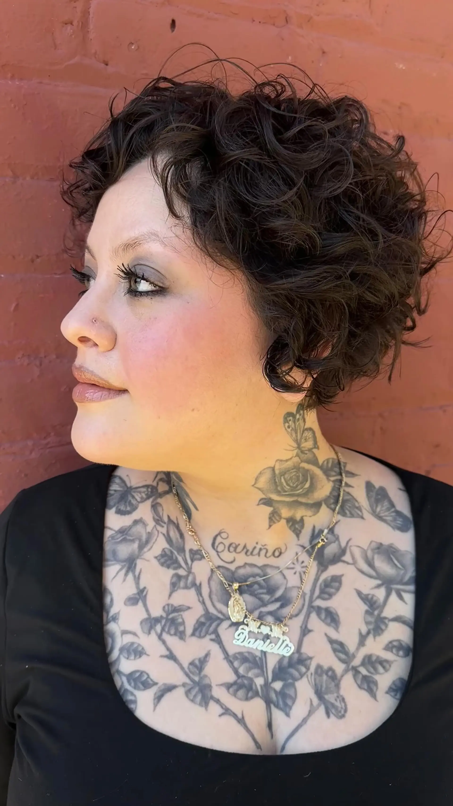 A textured short curly haircut with soft volume and defined curls around the face. 1
