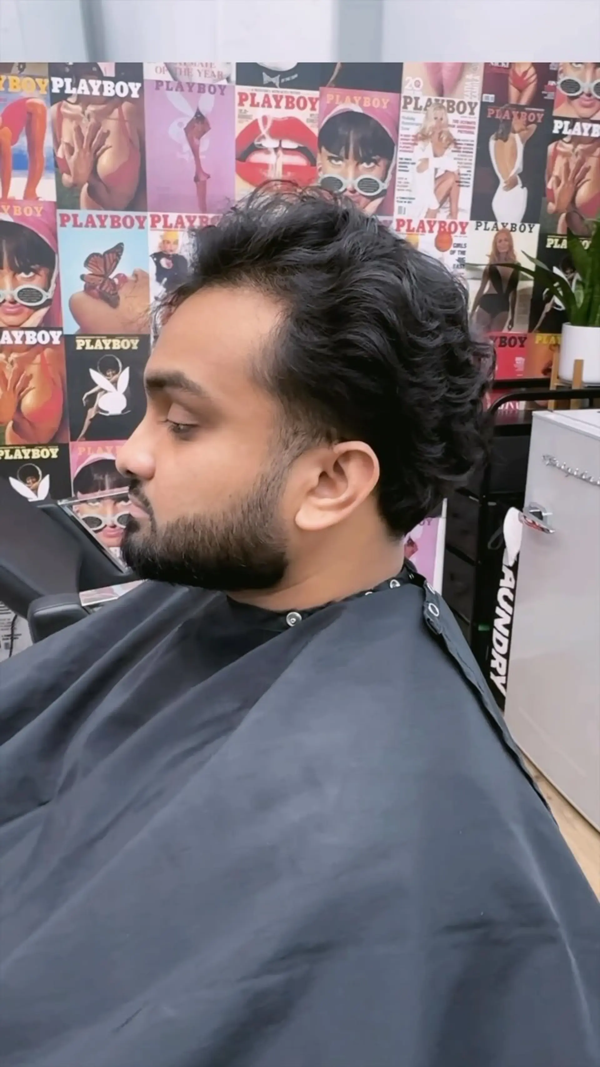 A medium-short textured scissor cut tailored for hair growth, featuring neatly debulked sides and a soft, natural taper around the neckline and ears. 1