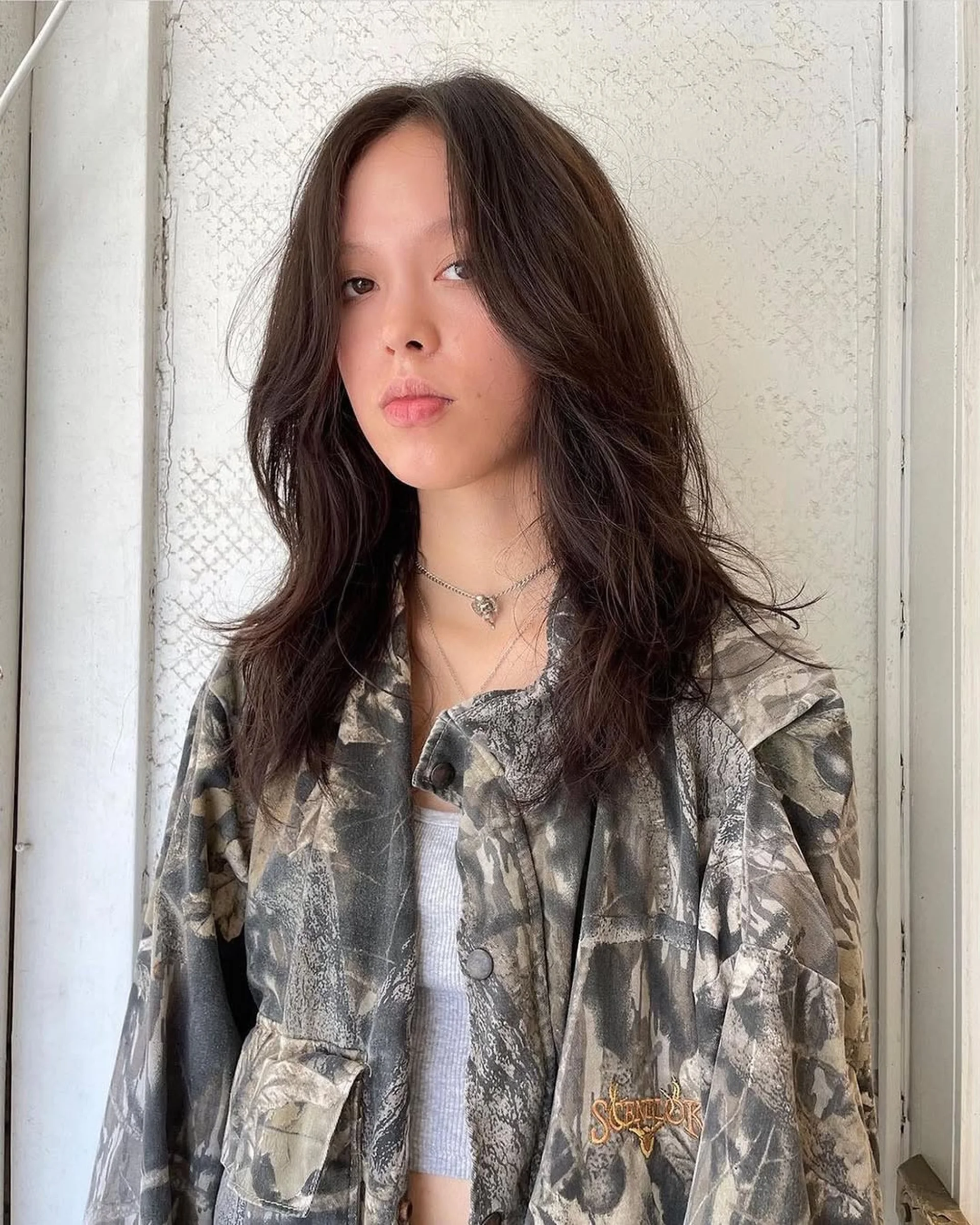 A mid-length curly shag haircut with full fringe bangs on brown hair, styled to enhance the natural curl pattern. - Preview 3