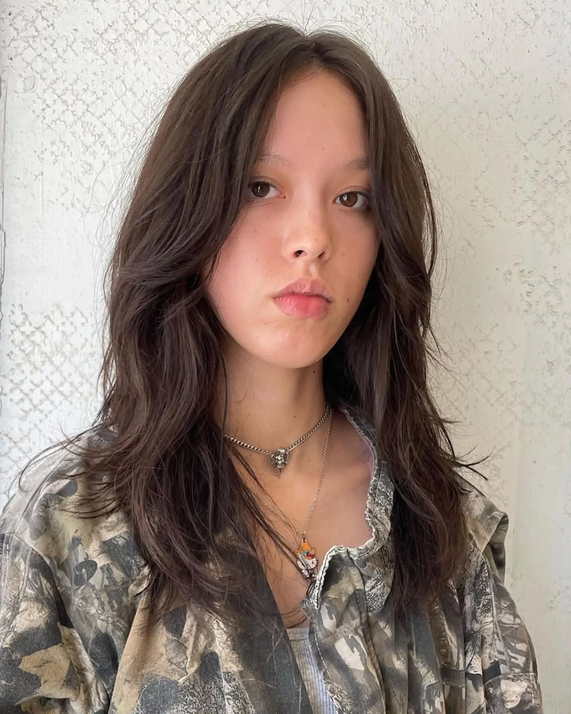 Medium-length, wavy dark brown hair with soft waves and face-framing layers. 3