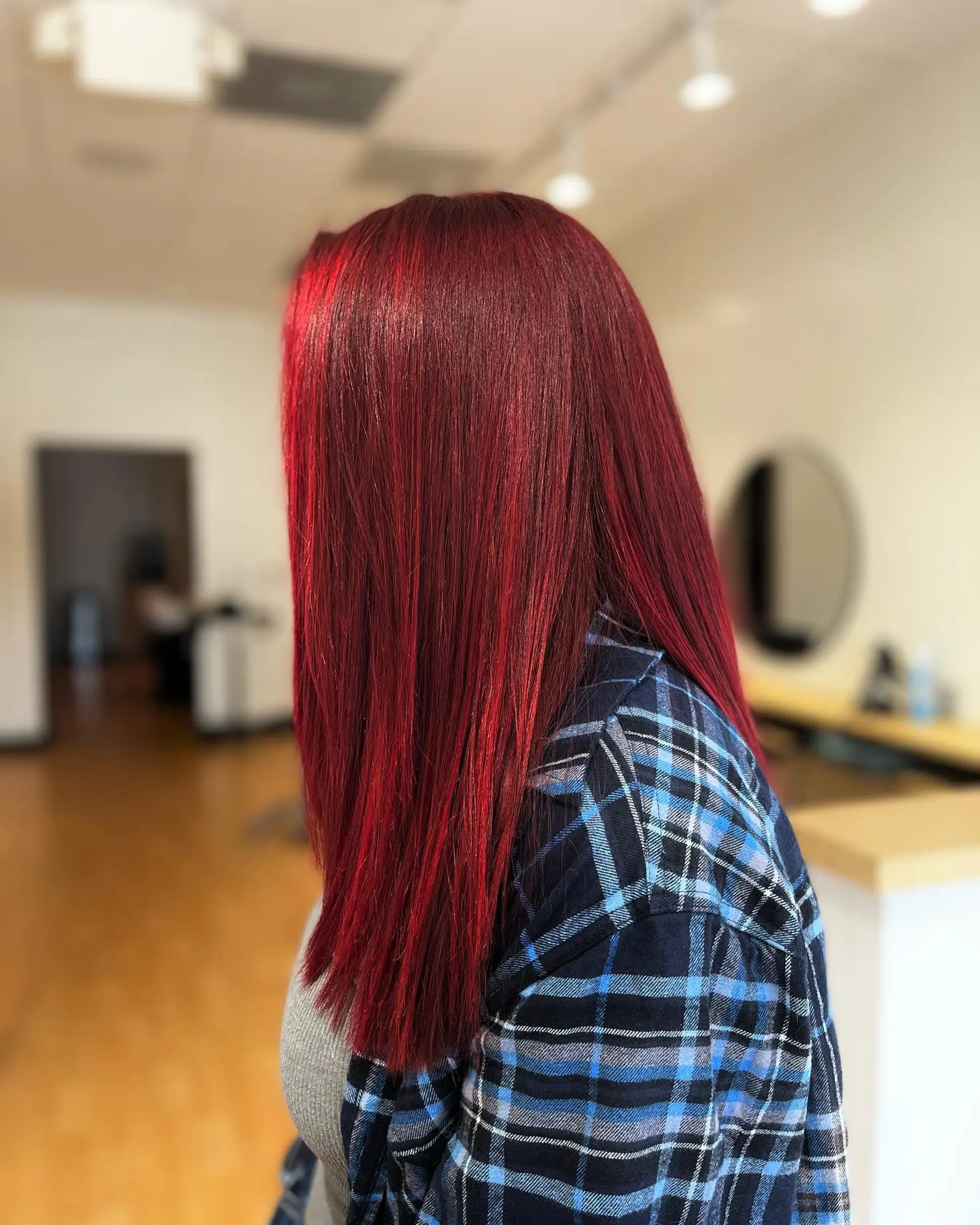 Vibrant crimson red long hair styled sleek and pin-straight with a glossy, reflective finish. 1