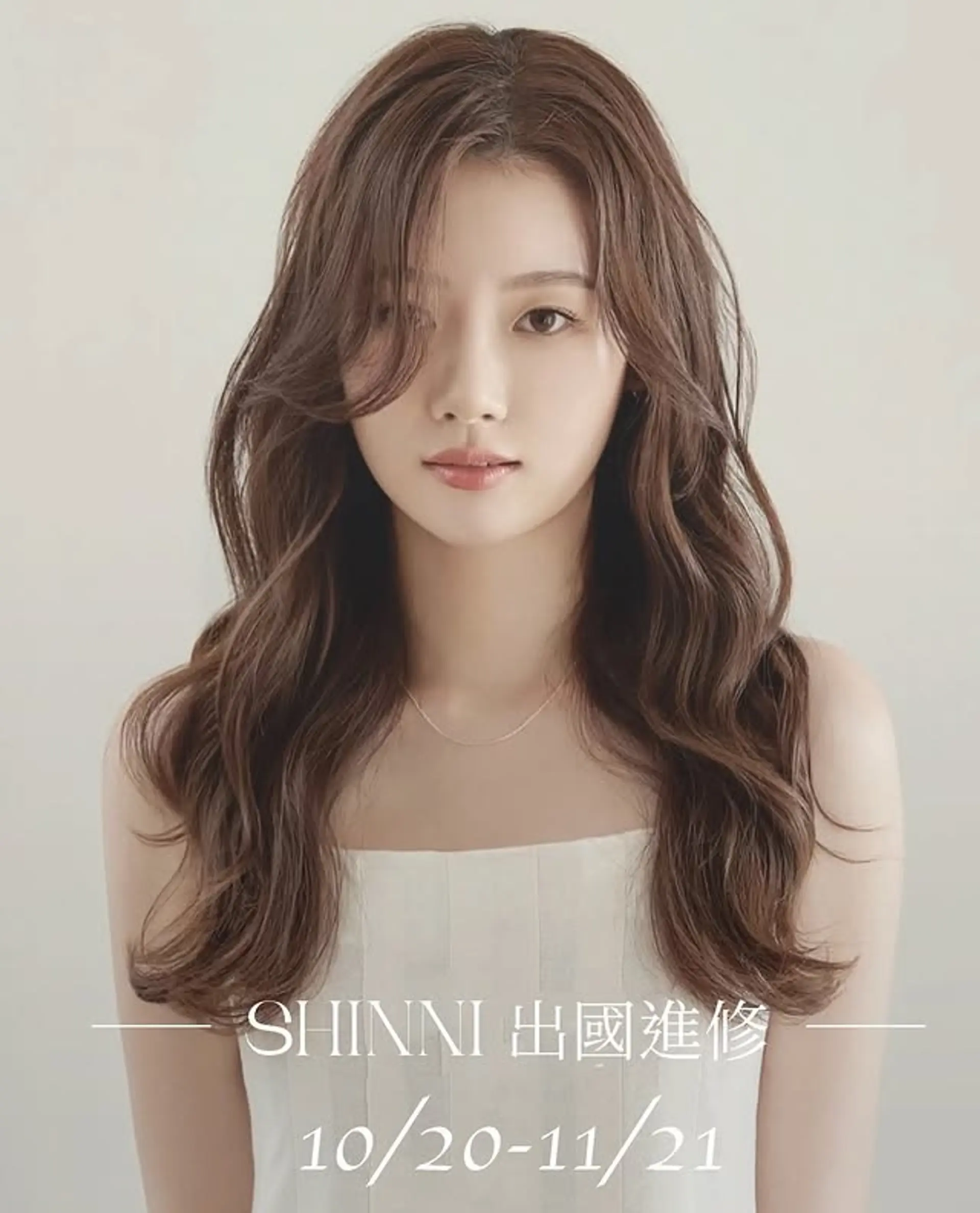 Long, wavy hair with face-framing layers and curtain bangs. 1