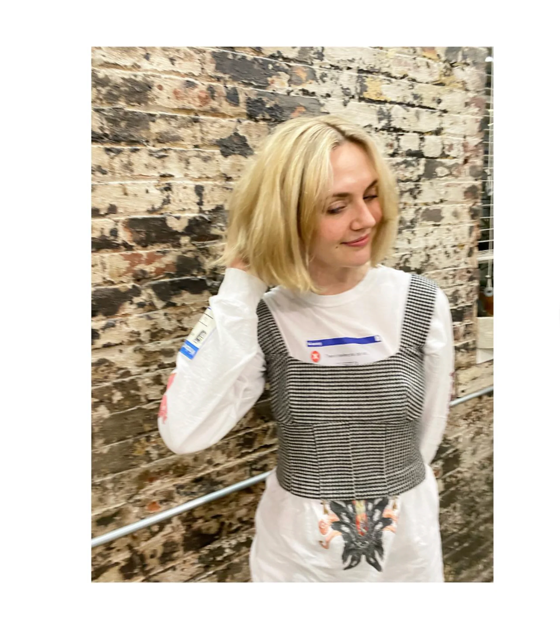 A woman sporting a bright blonde, shoulder-length blunt bob haircut, showcasing a modern and edgy aesthetic. - Preview 1