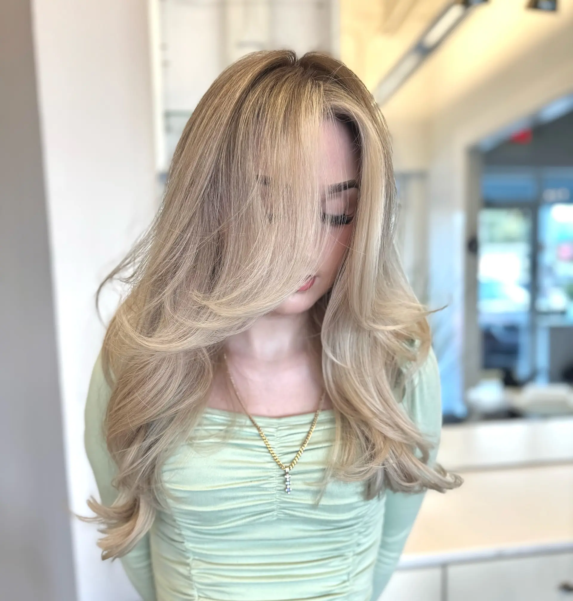 Long, wavy hairstyle with layered haircut and balayage. 1
