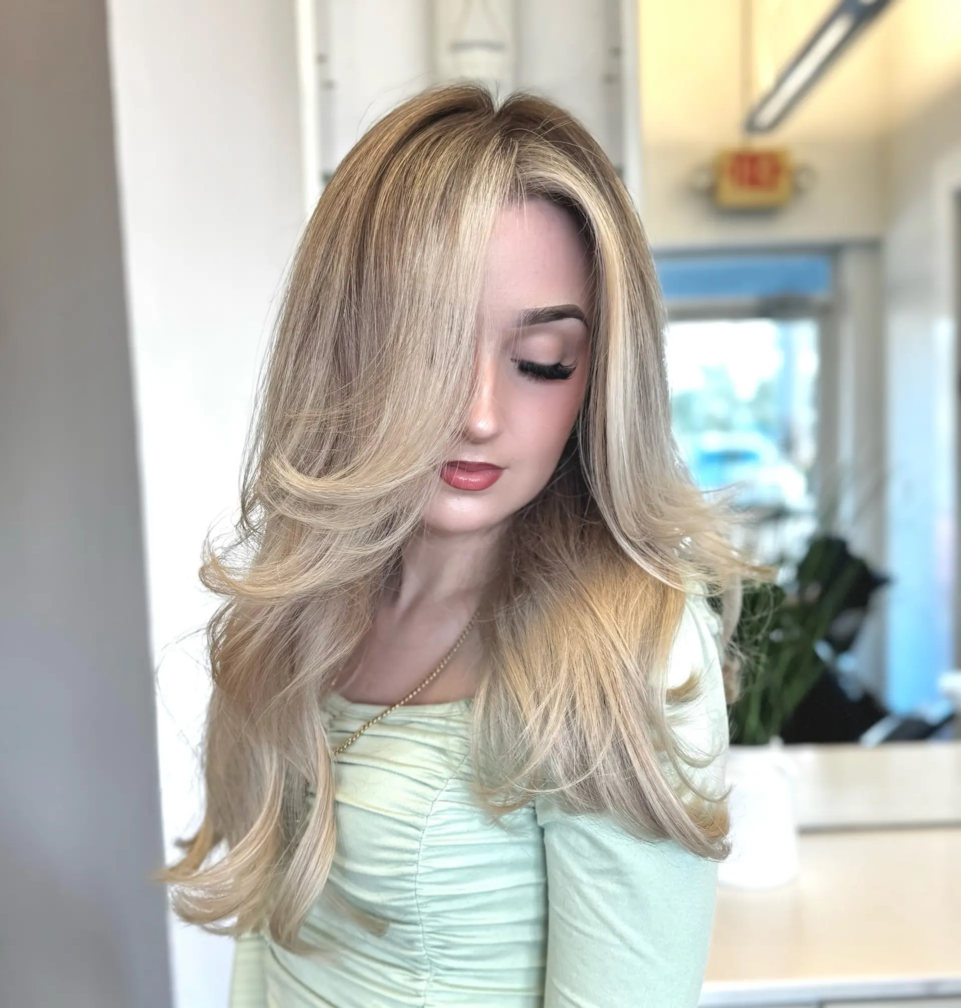 Long, wavy hairstyle with layered haircut and balayage. 4