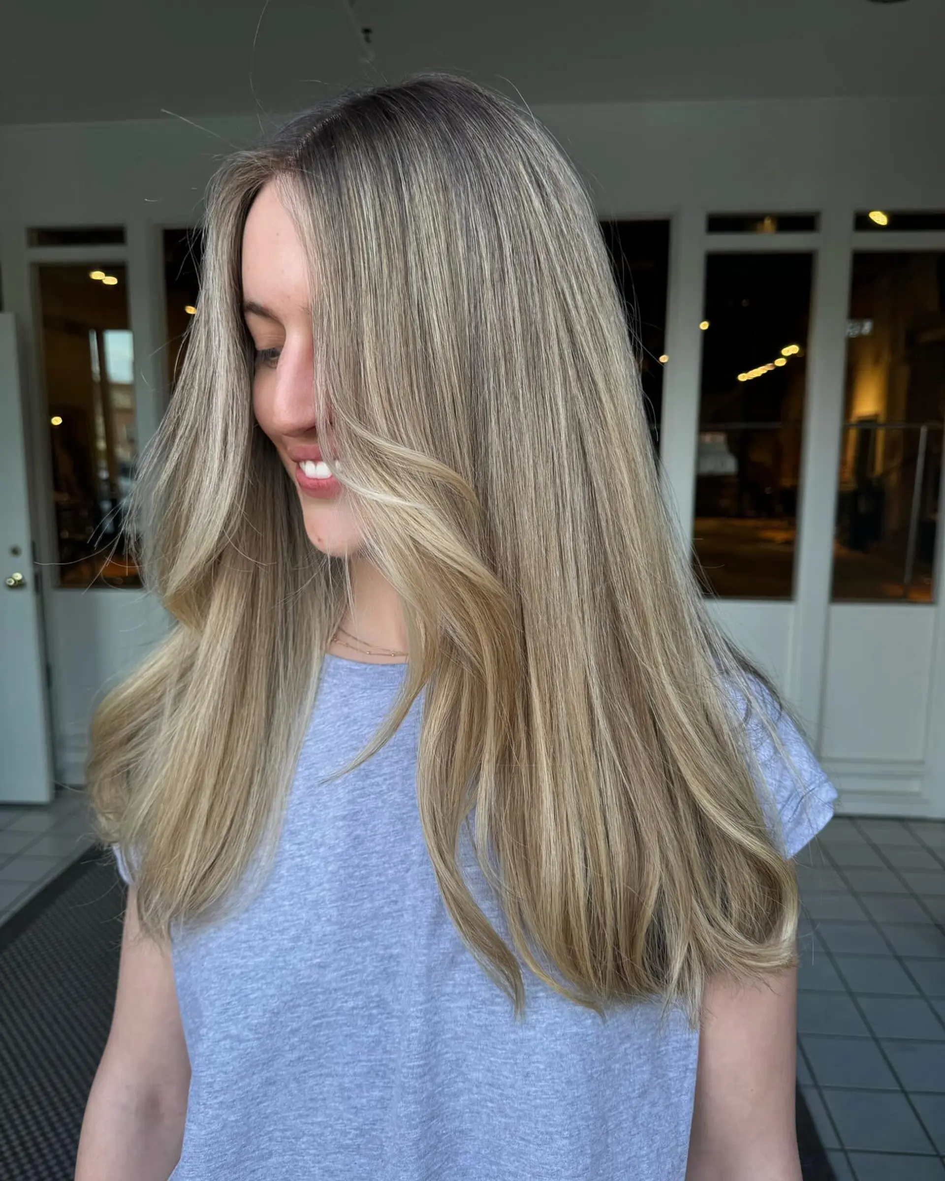 Long straight blonde hair with subtle face-framing layers and a blended shadow root. 1