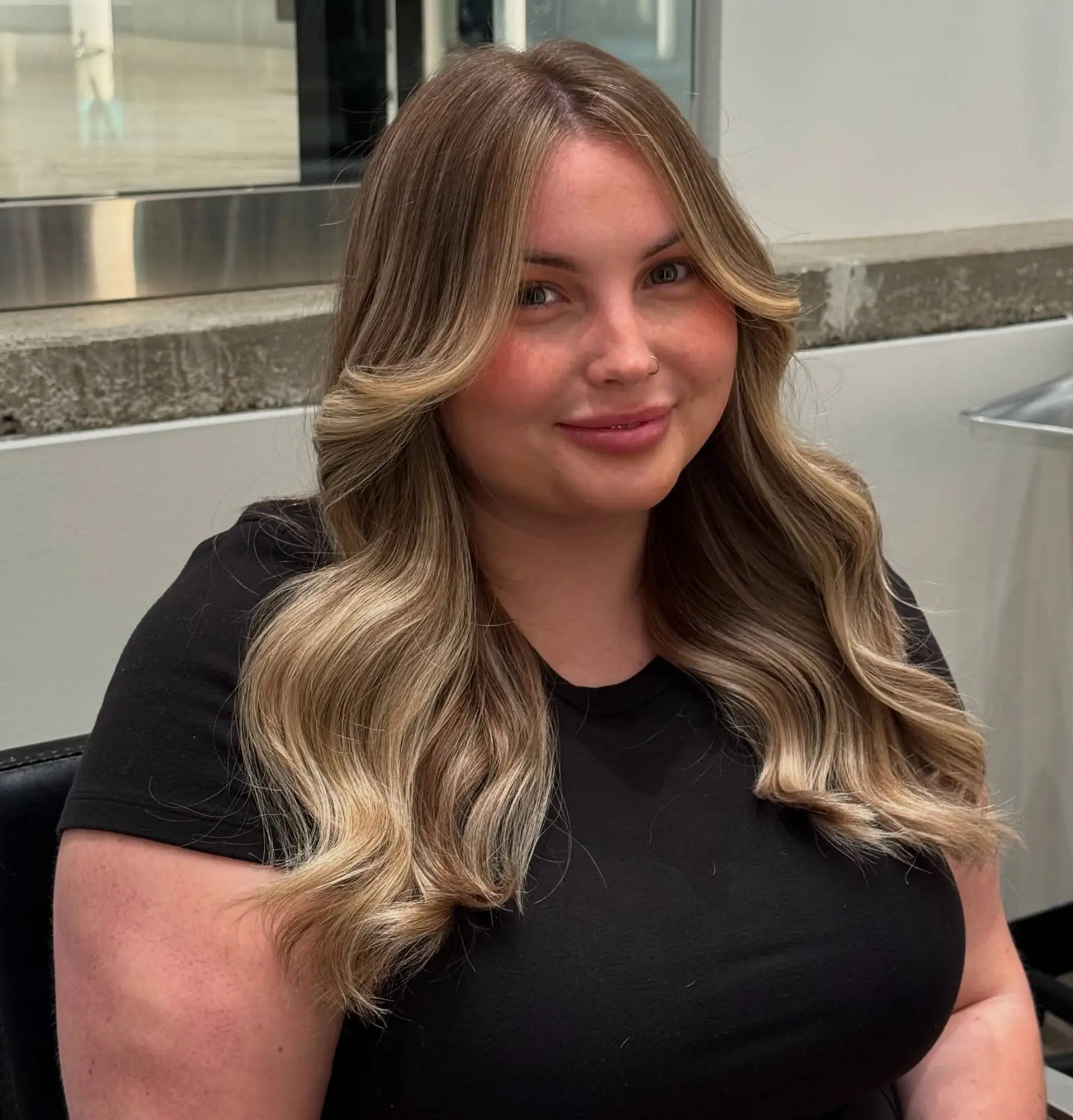 Long wavy hair with curtain bangs and face-framing layers. 3