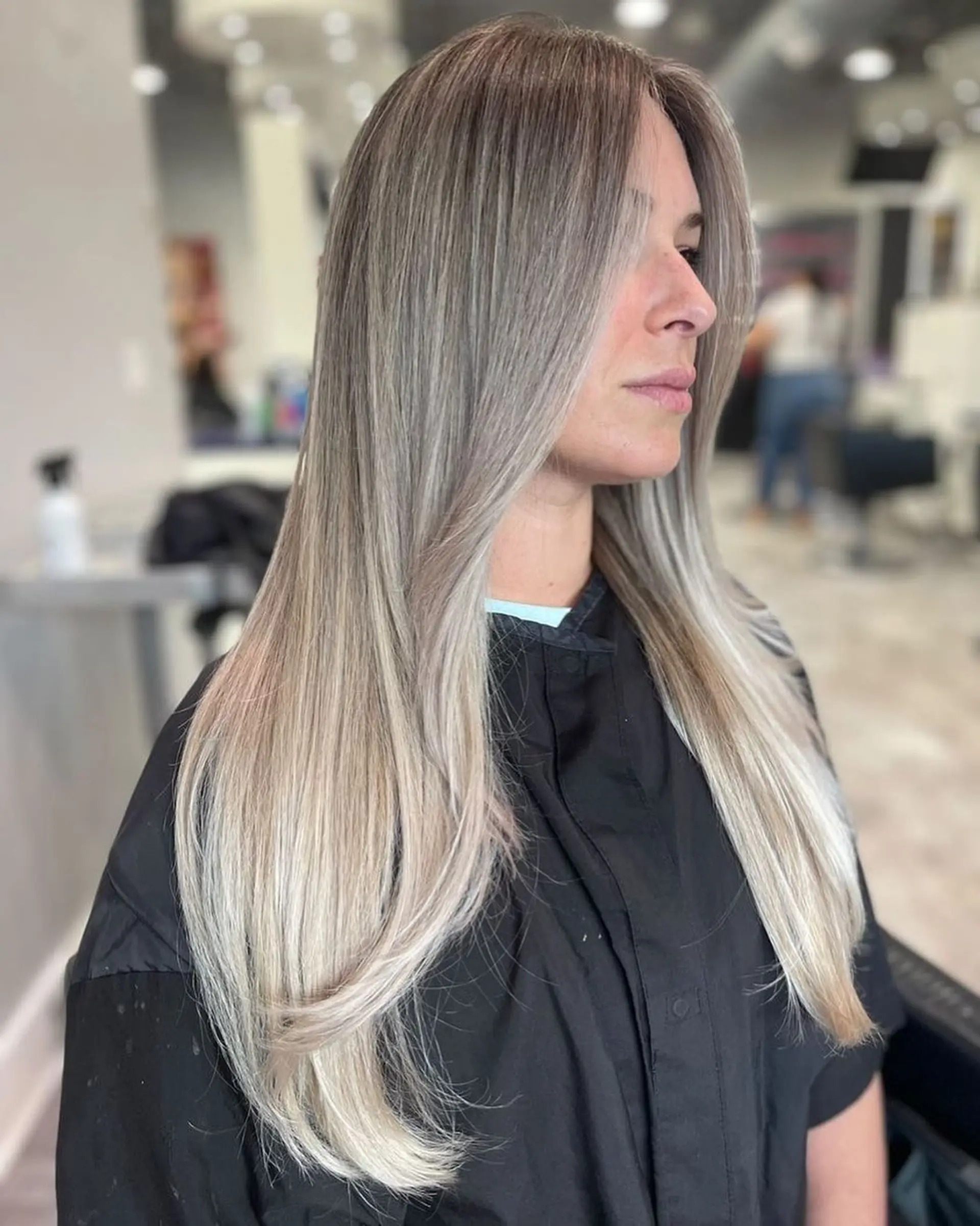 Long, straight hair with an icy blonde balayage and face-framing layers. 1