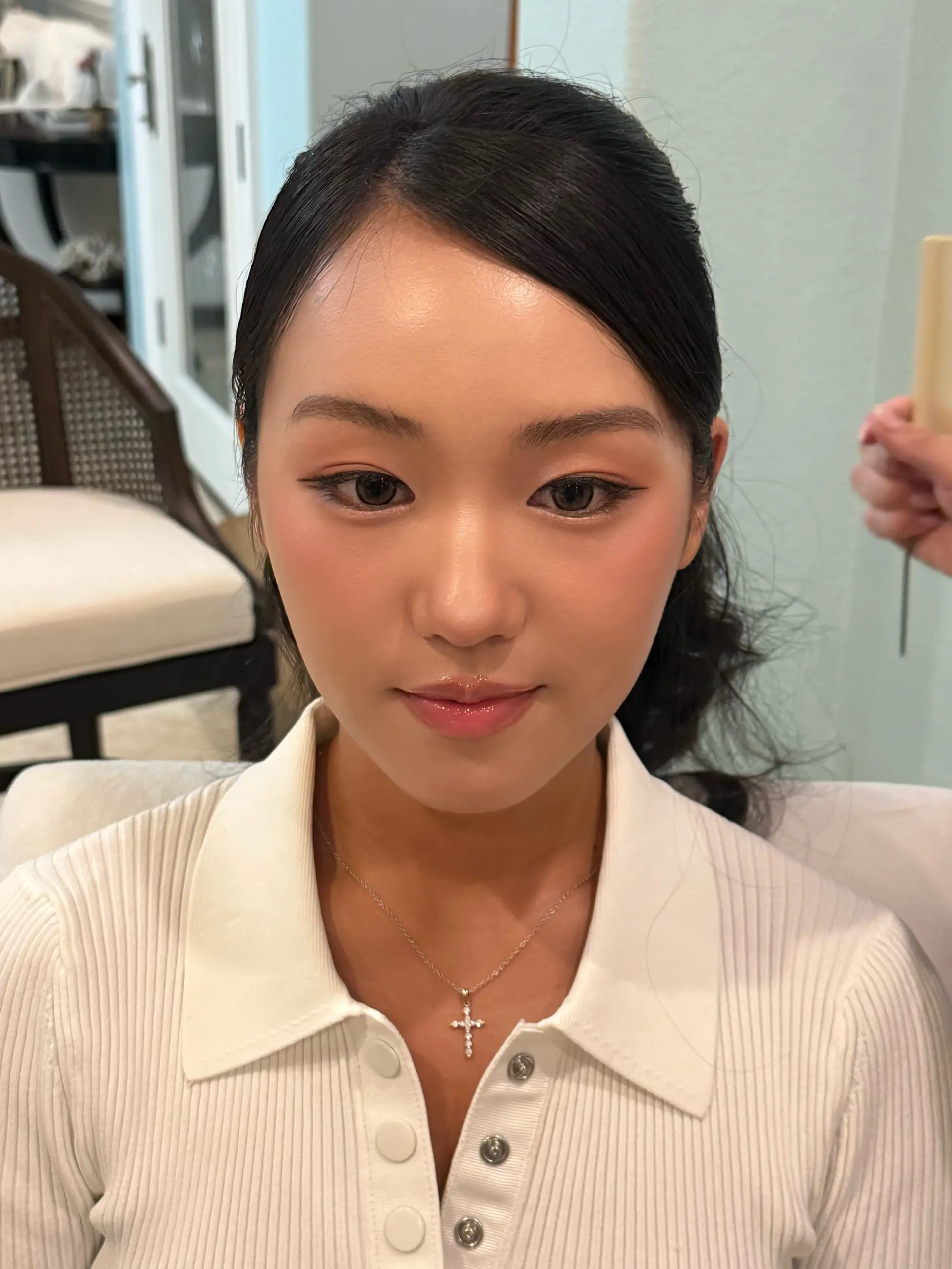 A polished and sleek side-parted hair styling neatly pulled back into an elegant low updo. 1