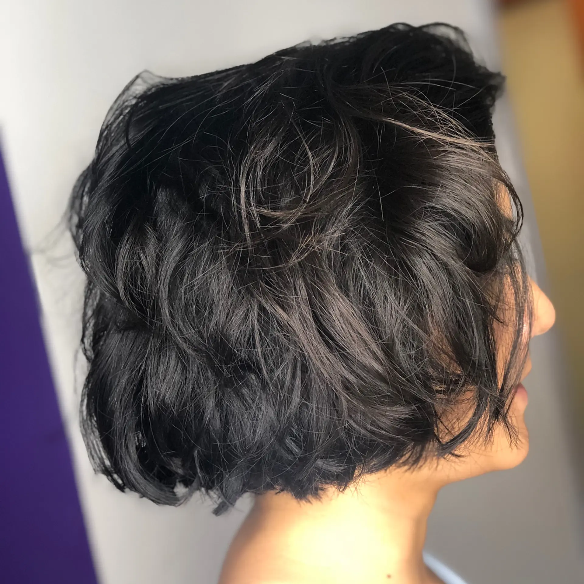 A soft, chin-length layered bob with tousled waves and natural texture throughout. 1