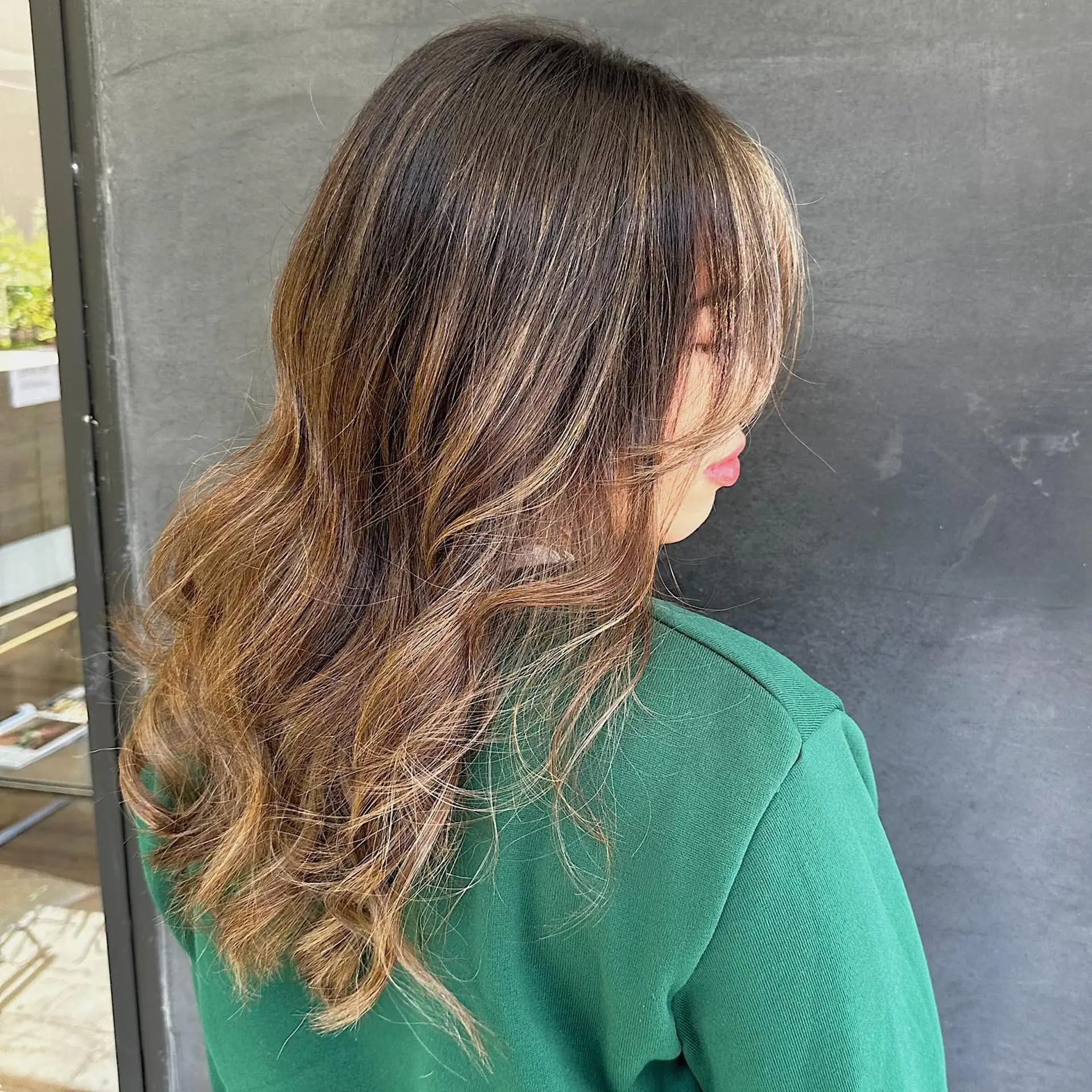 Long wavy hairstyle with a bronde and blonde balayage, featuring layers and face-framing. 1