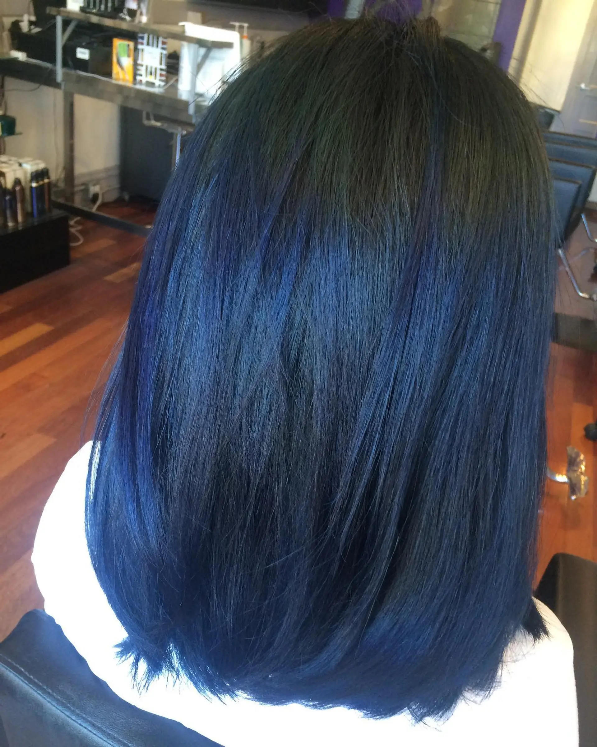 Medium-length straight hair featuring a deep midnight blue balayage blended over a natural dark base. 1