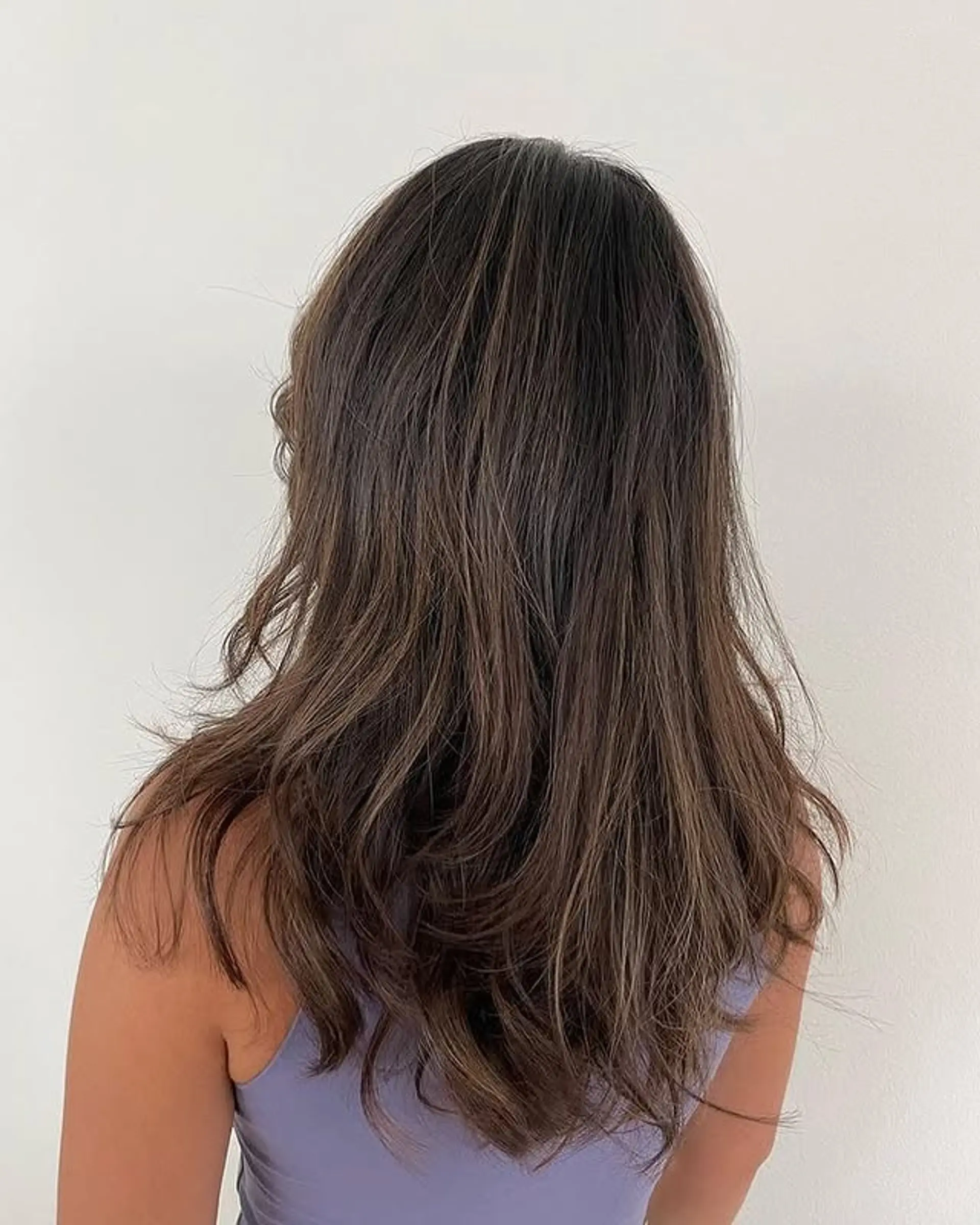 Long layered brunette hair with a subtle balayage. 1