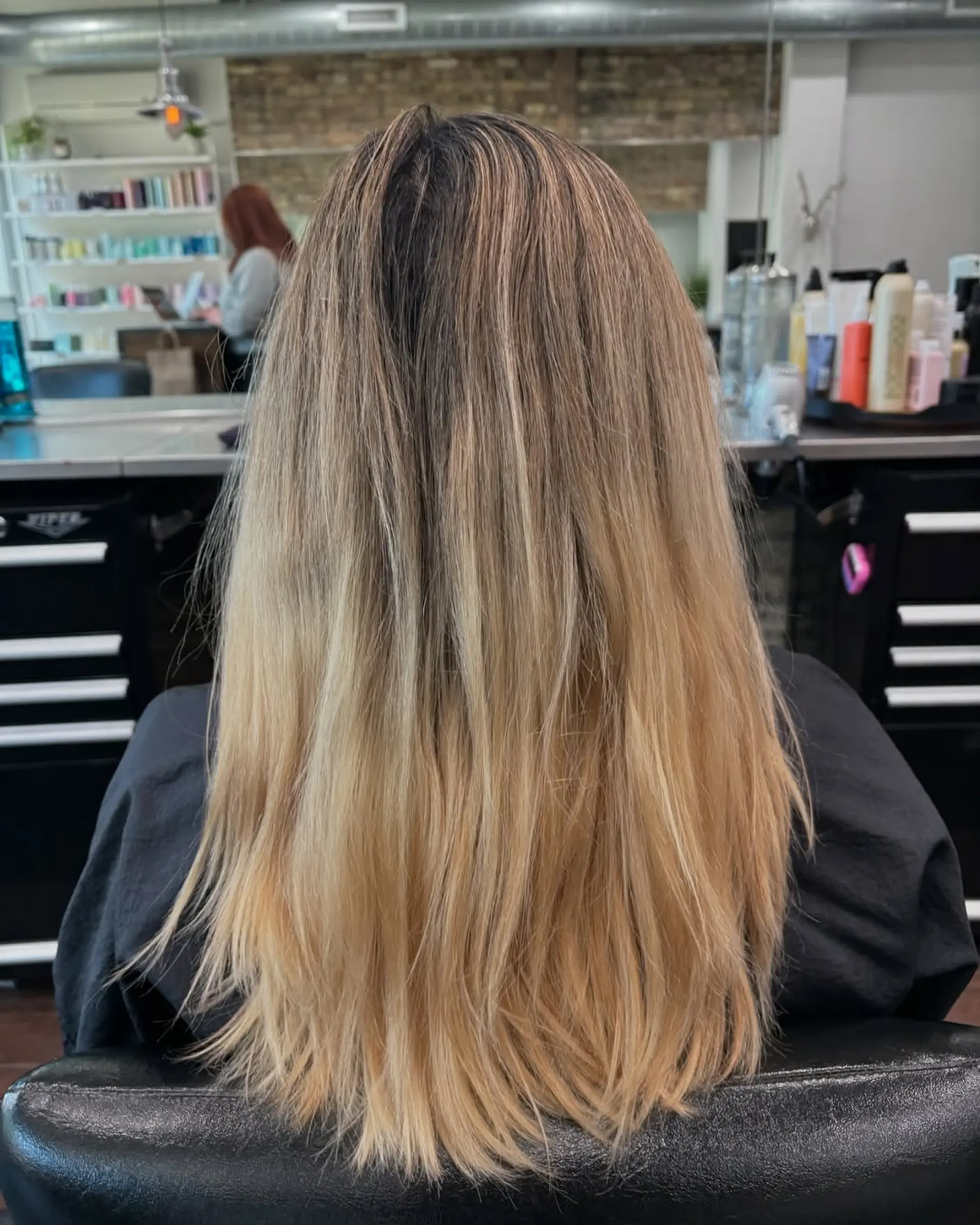 A chic medium-length haircut with soft face-framing layers and subtle longer layers throughout, enhanced by a dimensional caramel and light brown balayage that adds depth and a sun-kissed glow. 4
